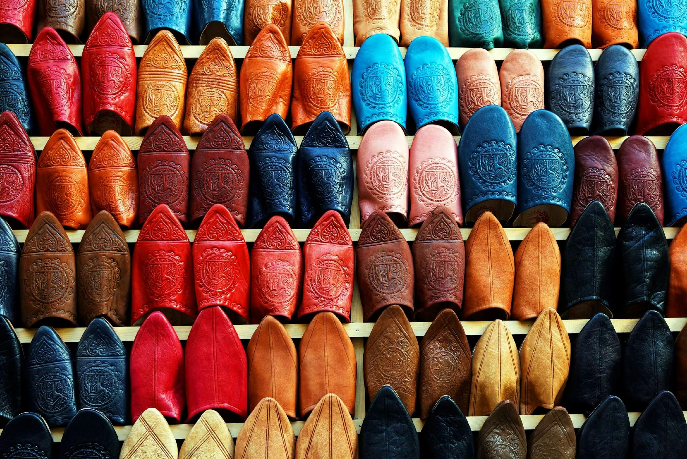 Dozens of pairs of leather slippers in all different colours on display in Marrakesh.