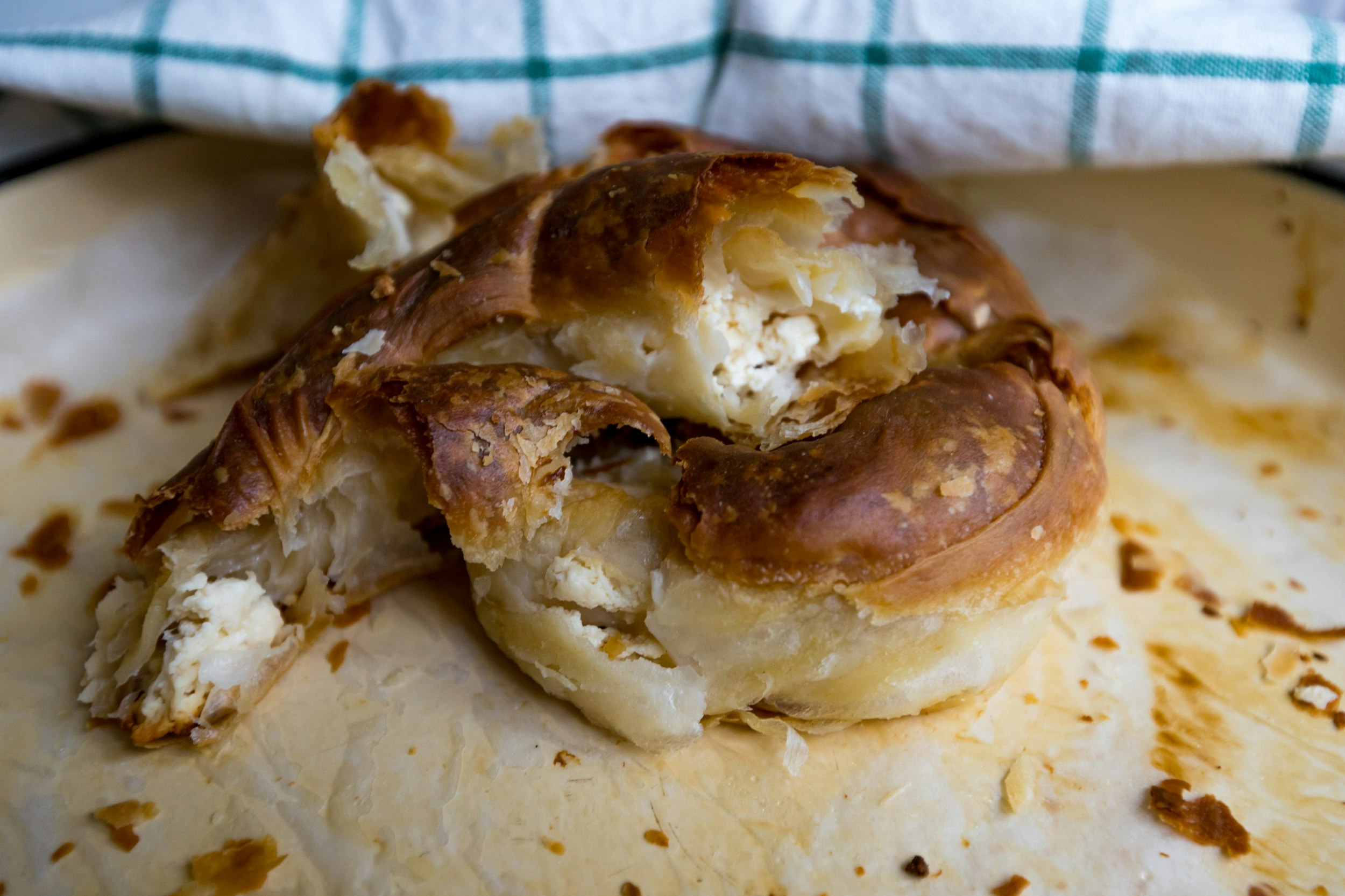 A golden pastry swirl cut to reveal a white cheese filling