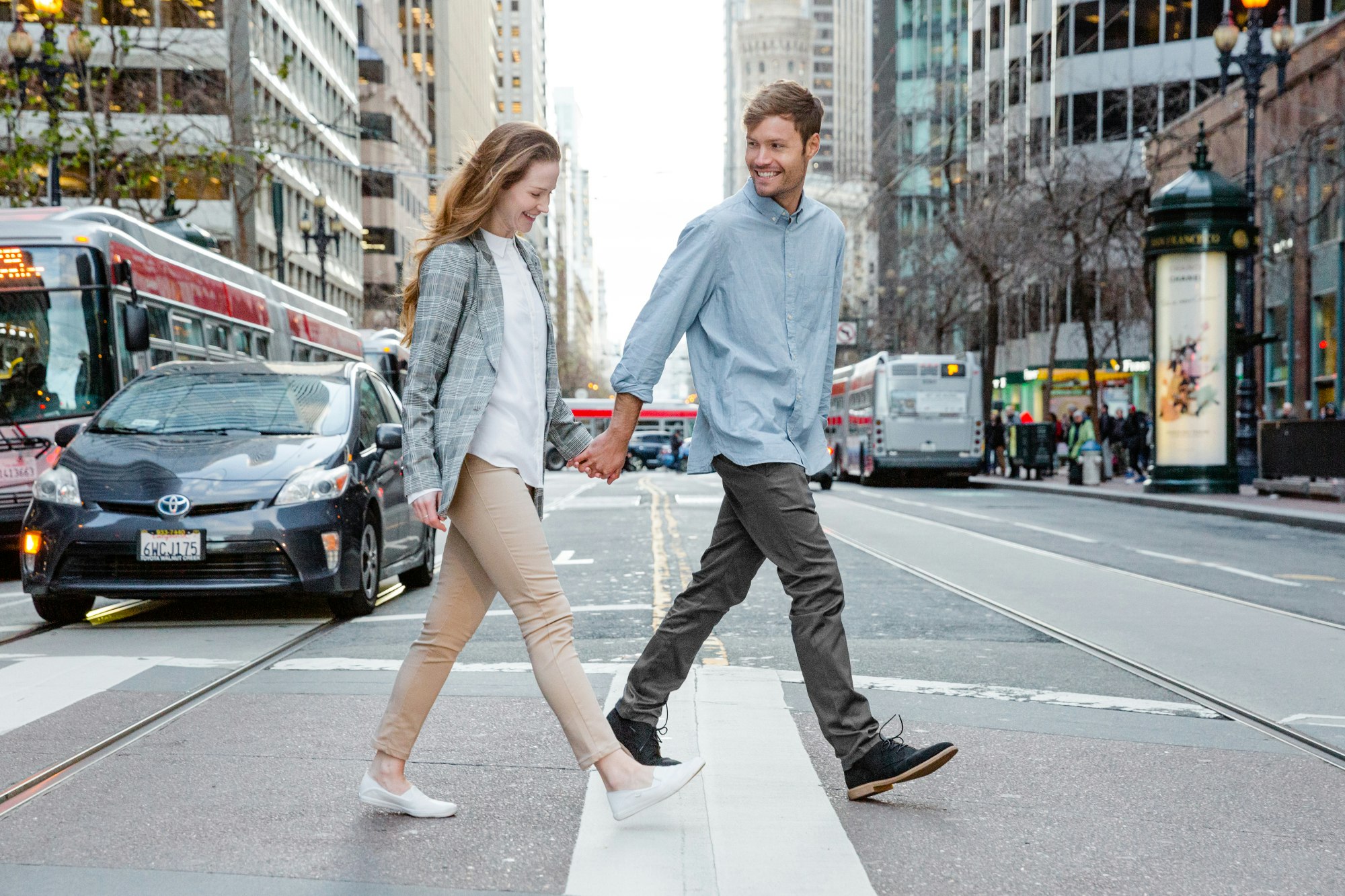 A man and woman walking through a city wearing the travel pants