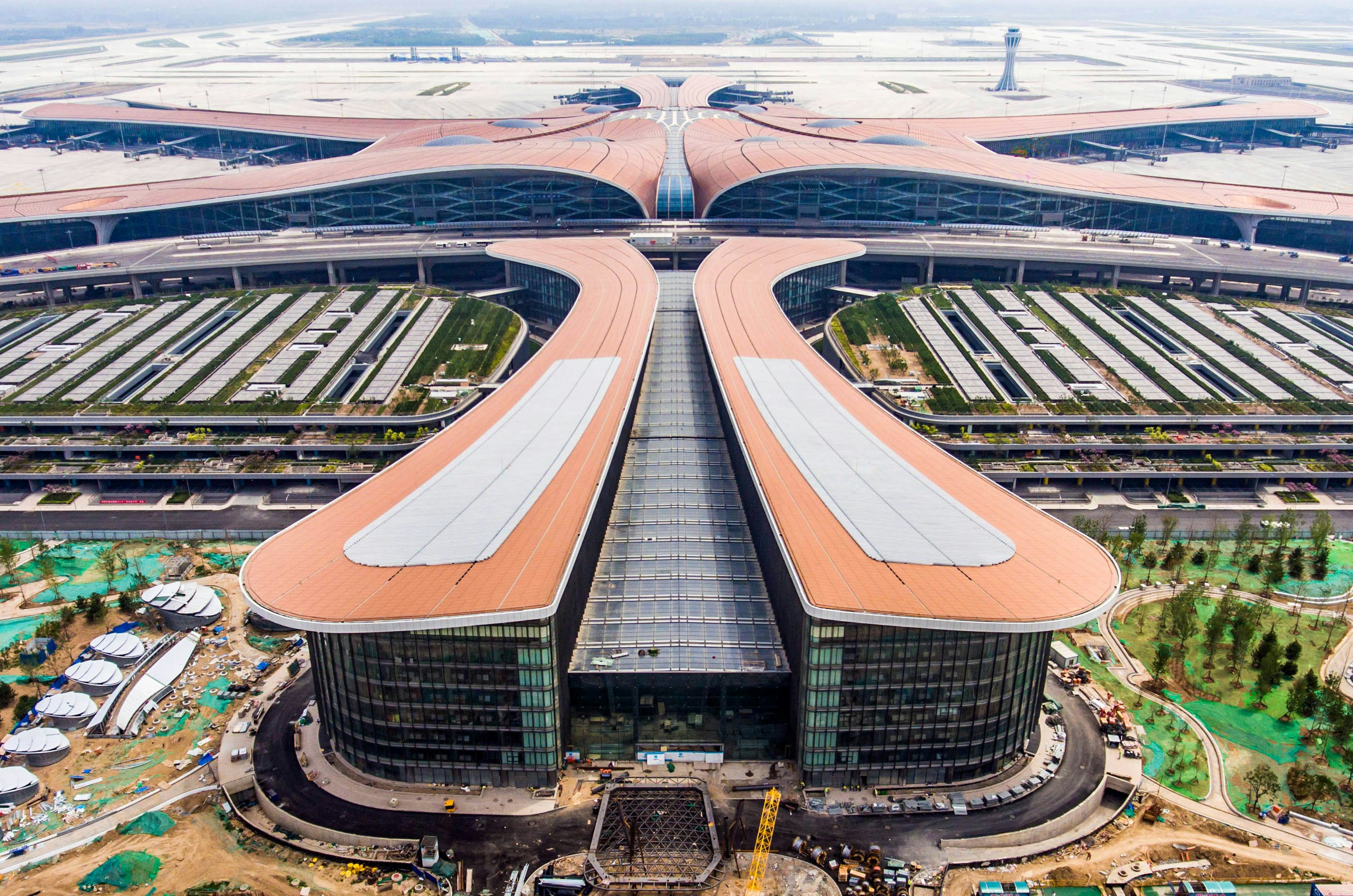 An aerial image shows the futuristic orange airport in China. 