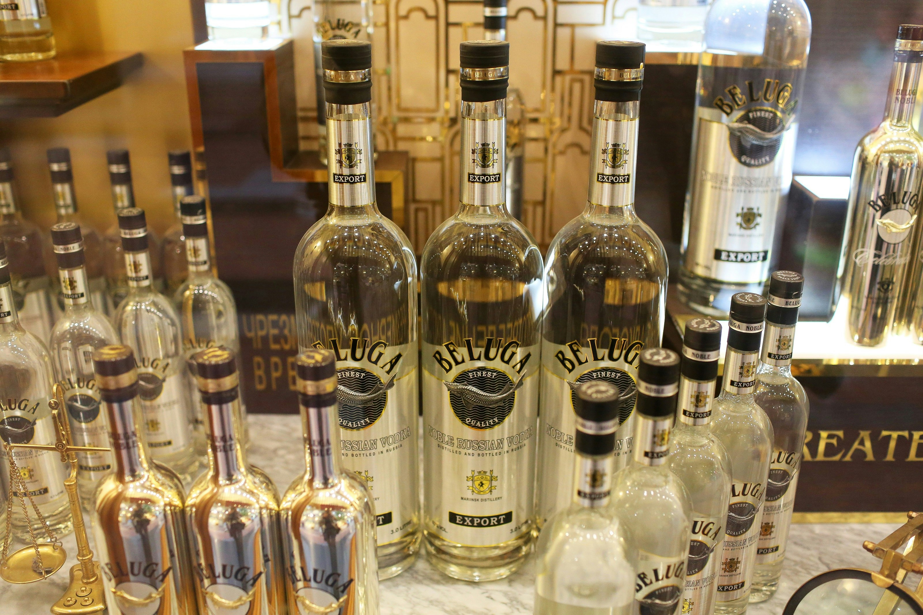 Approximately twenty different vodka bottles arranged in a neat display. All are labelled Beluga Finest Quality Vodka.