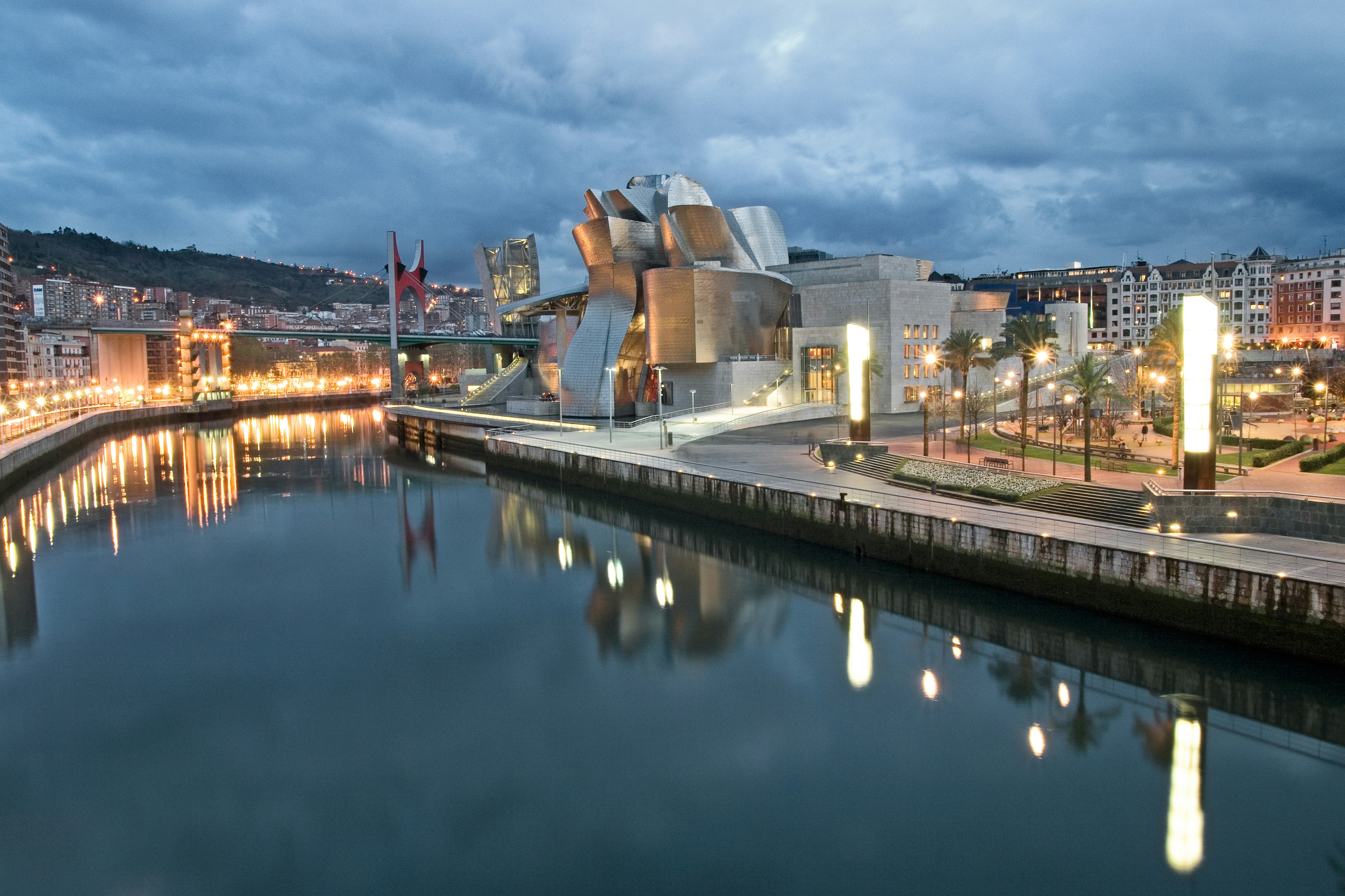 The Guggenheim Museum on the banks of a river. 