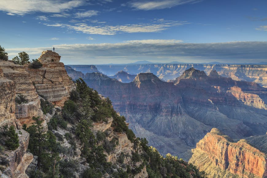 A hiker stands above the Grand Canyon's North Rim