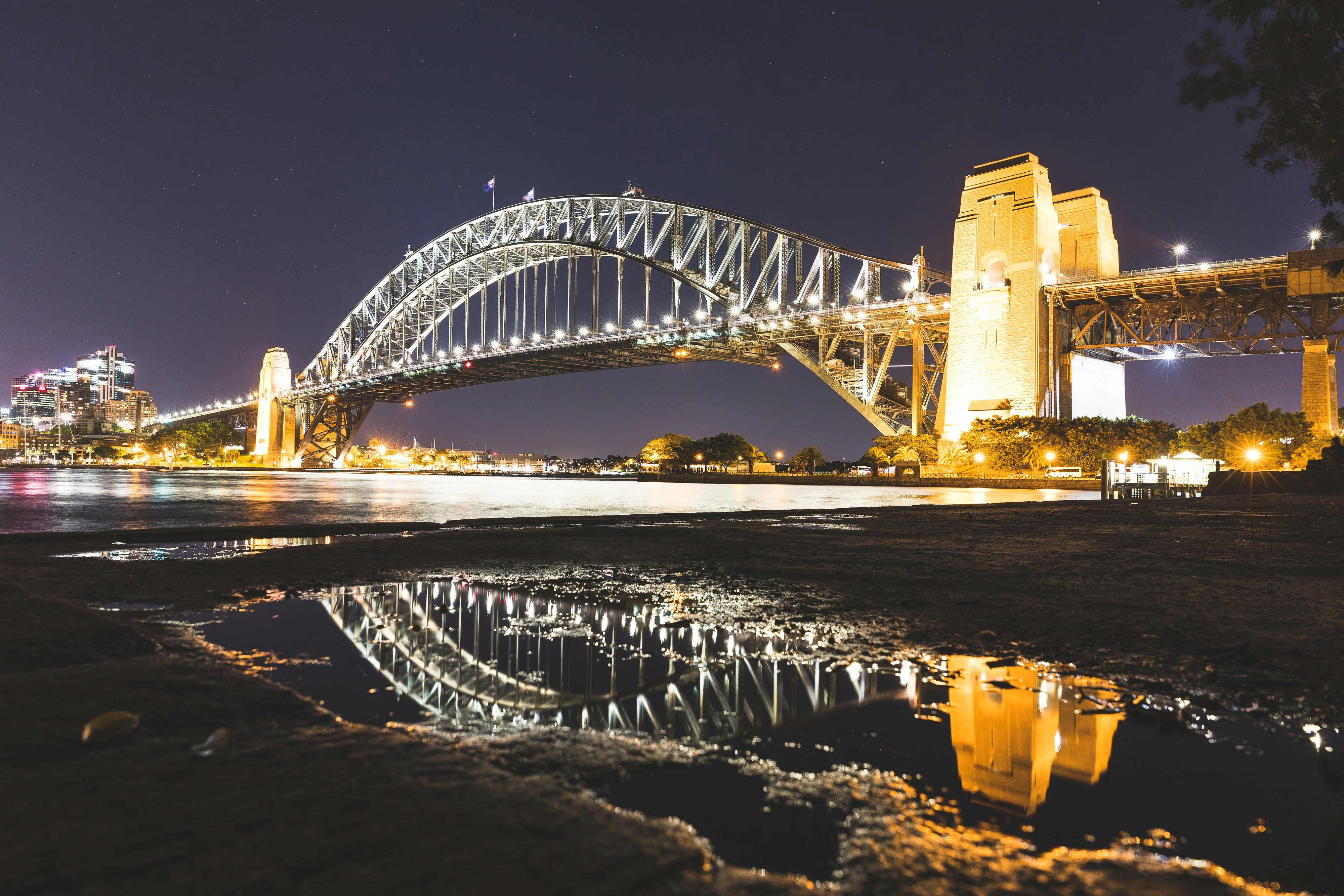 A picture of Sydney Harbour Bridge at night, illuminated by streetlamps