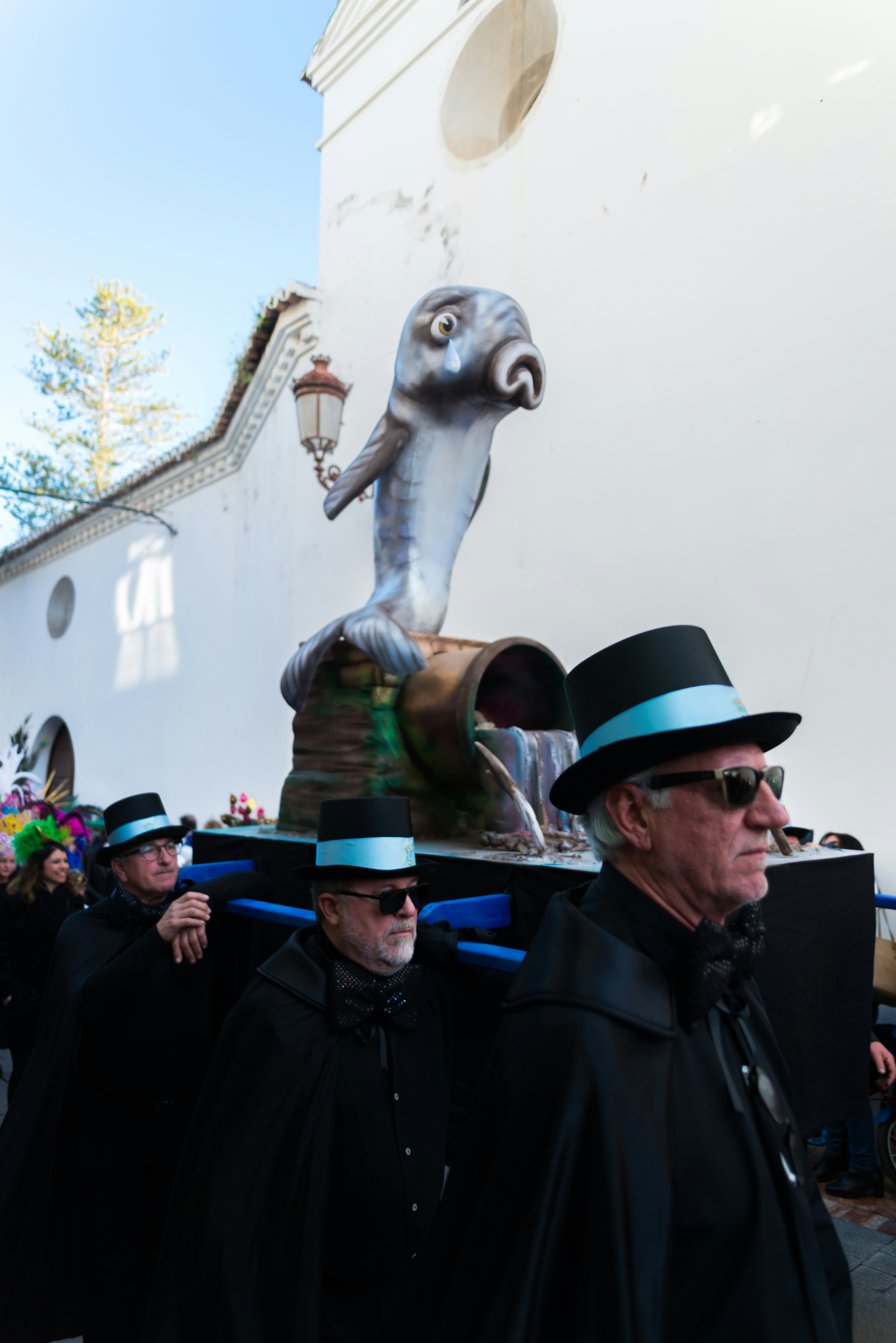 An effigy of a weeping sardine is carried by people dressed in black in a procession during the Burial of the Sardine at Carnival in Spain.