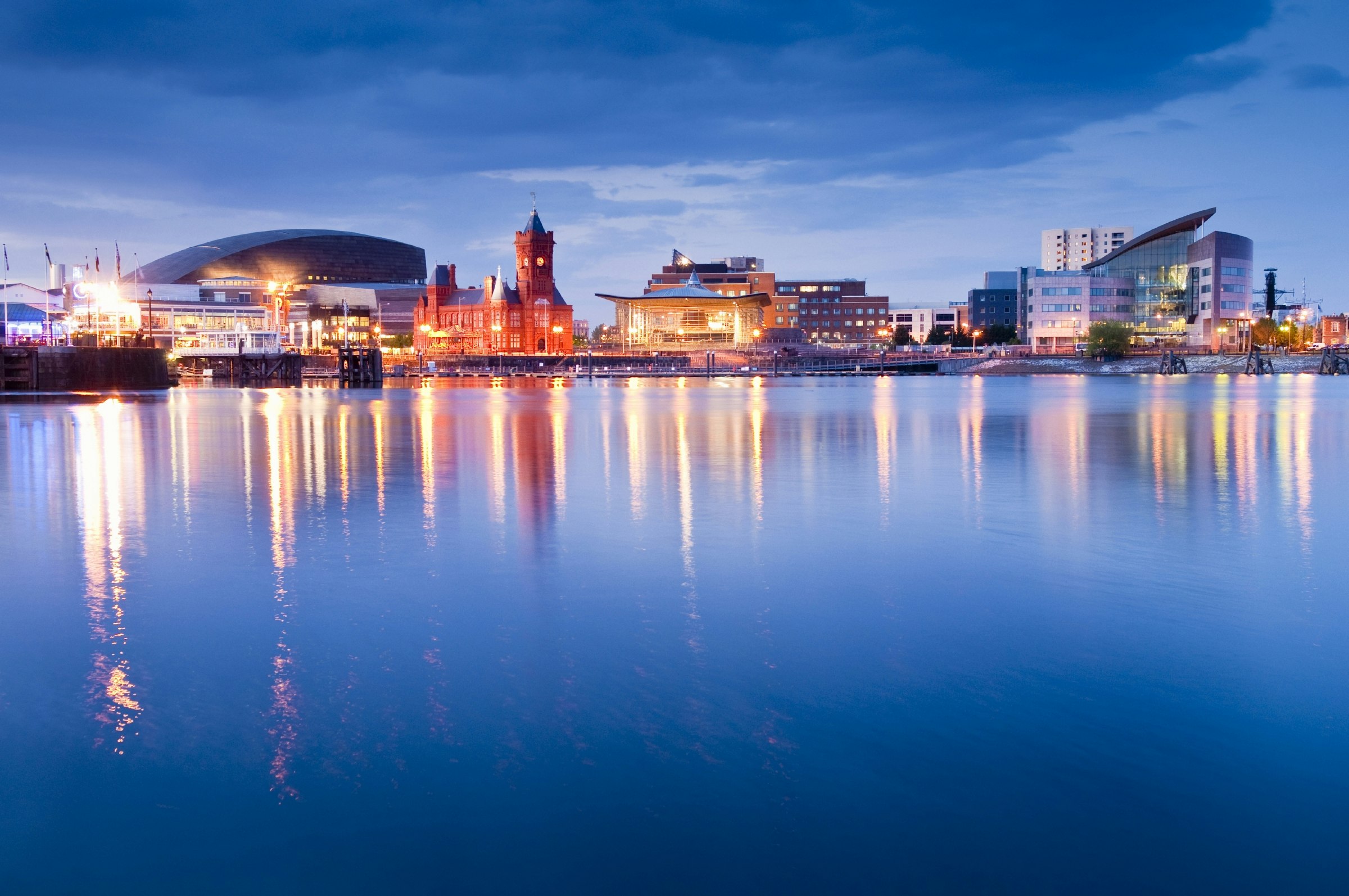 The buildings that line Cardiff Bay lit up against the night sky.
