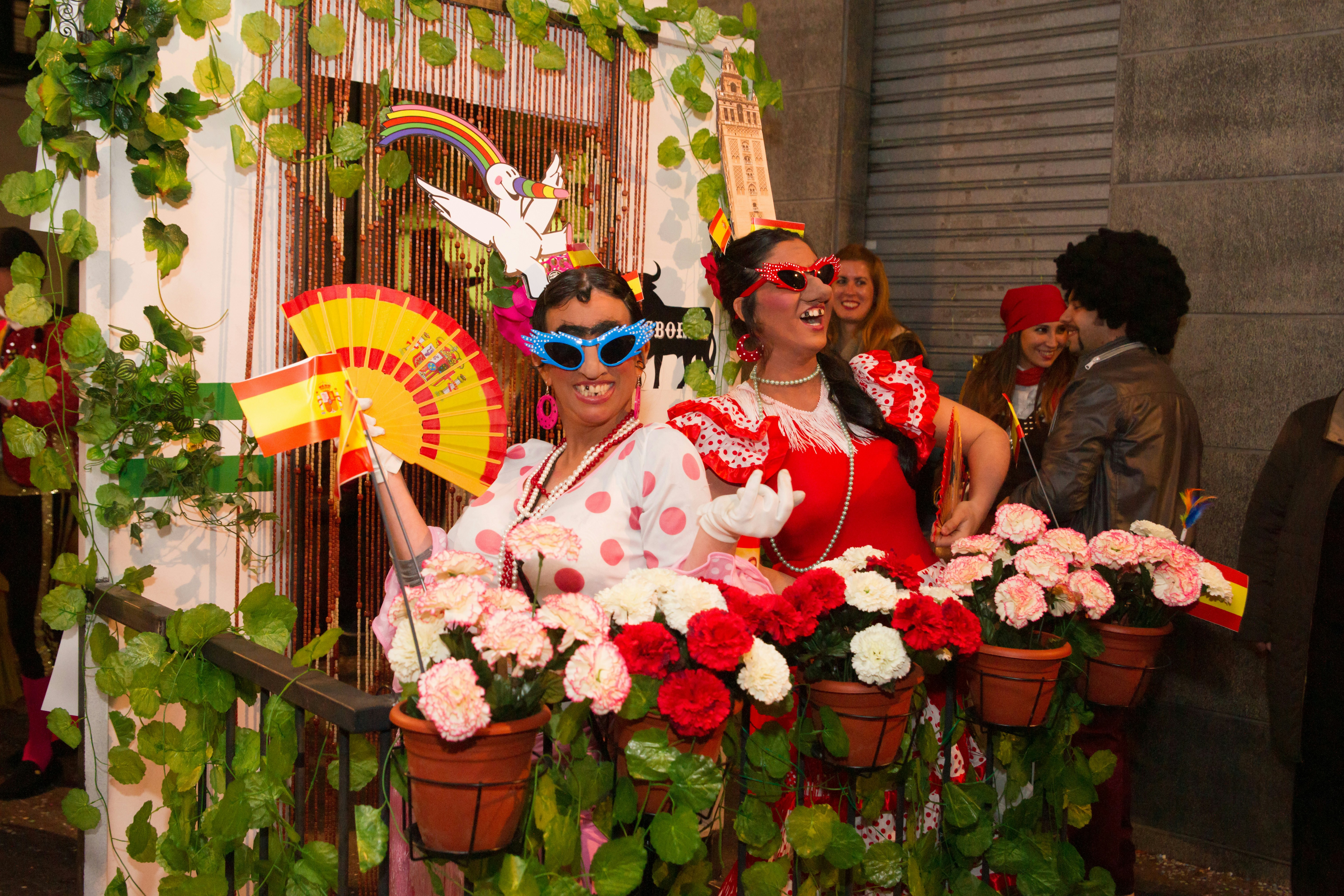 Women dressed in comical Spanish costumes on a float at Sitges Carnival, Spain.