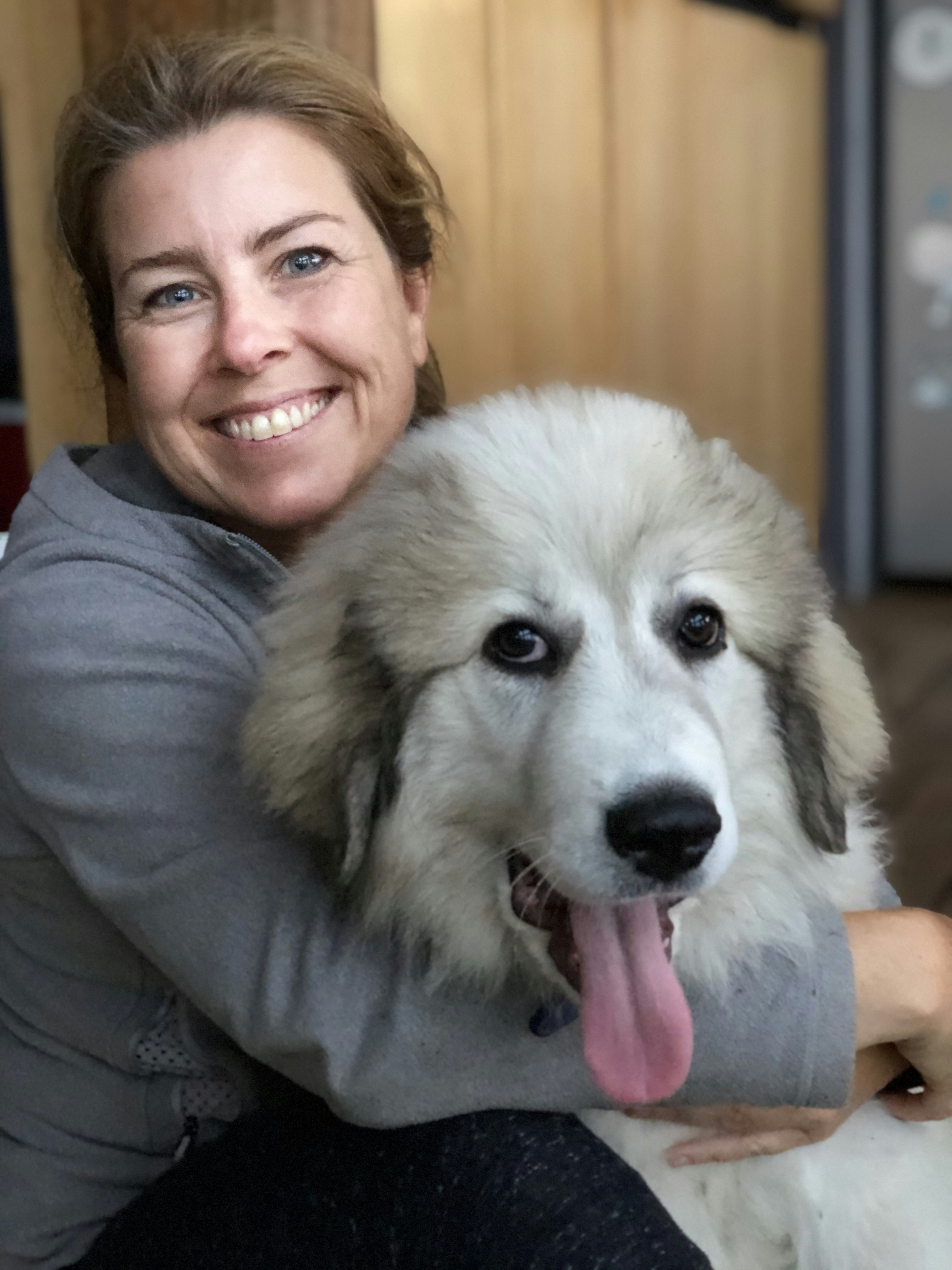 A woman with a white dog