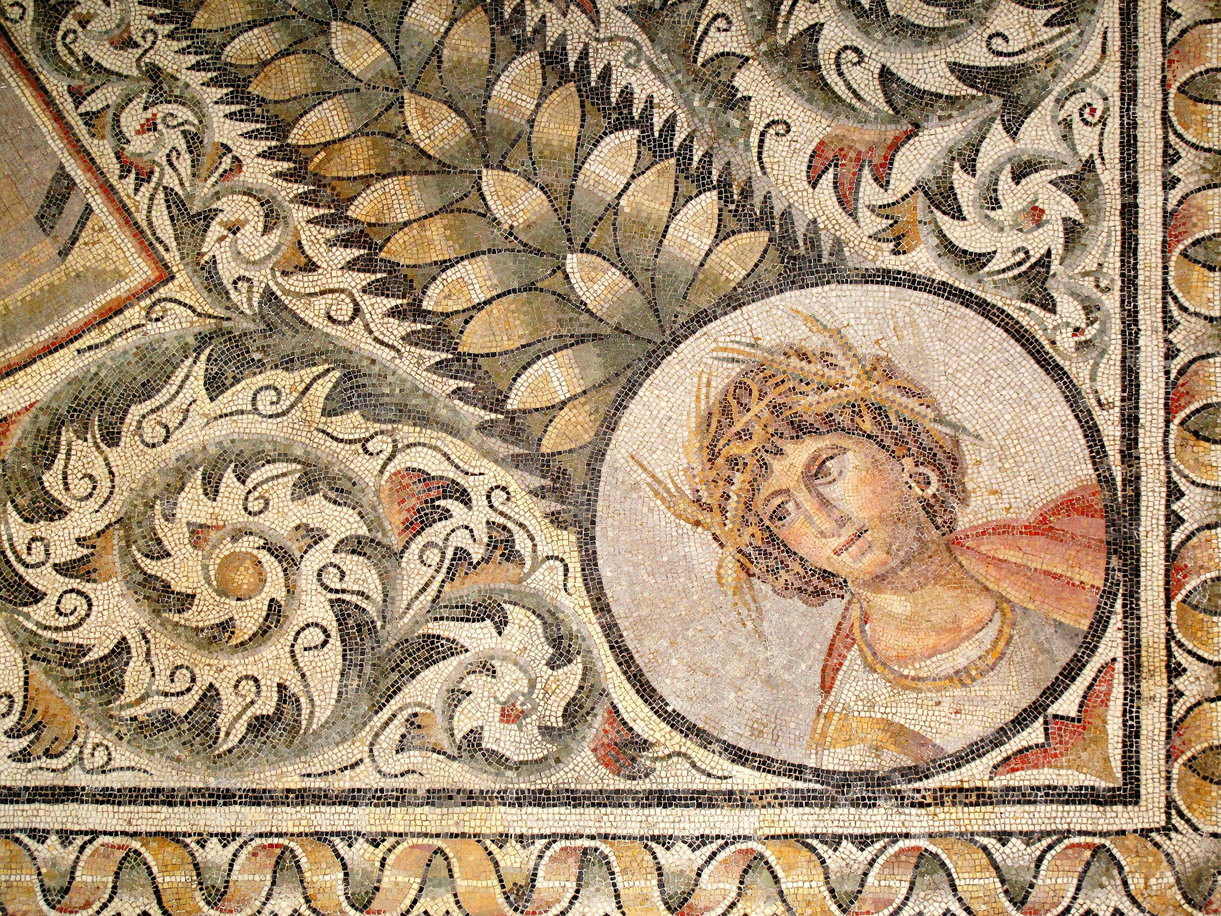 Mosaic of the 4th century from Carthage depicting July from a corner section of a months and seasons pavement, with a medallion of summer wreathed with ears of corn.