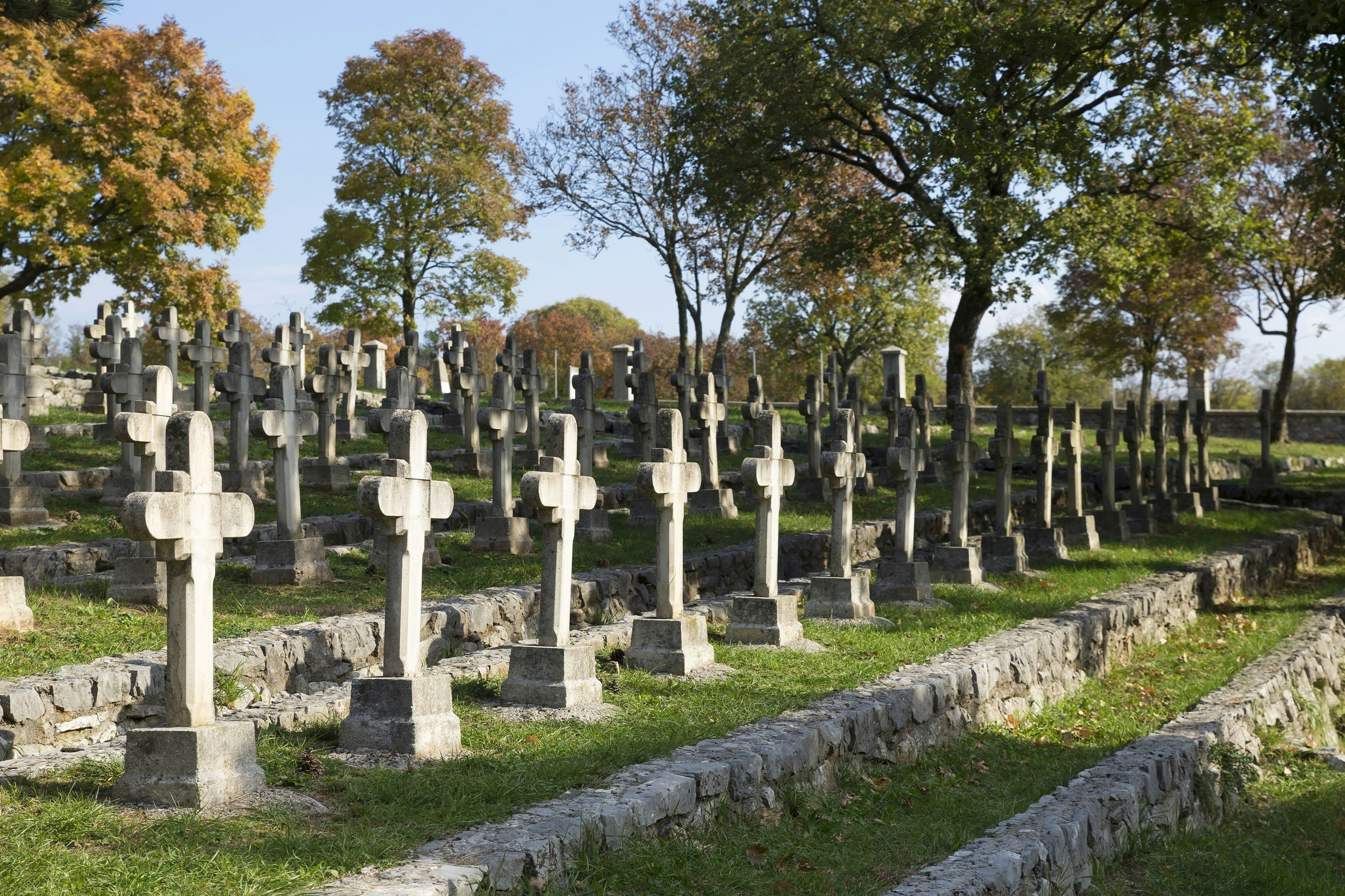 Rows of stone crosses mark graves in a cemetery