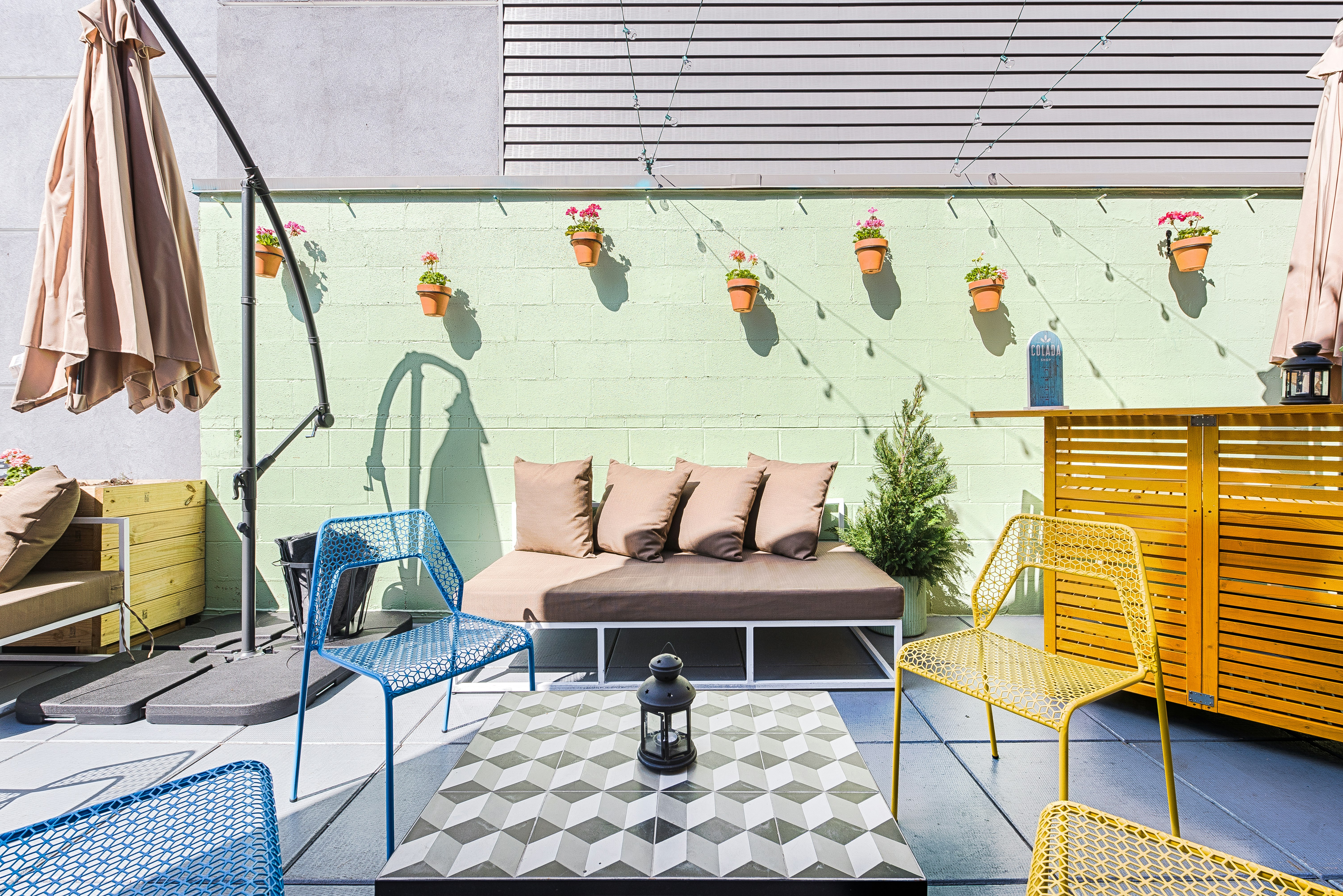 The walls and artistically arranged minimalist furniture has been painted in pastel shades at Colada Shop rooftop bar.