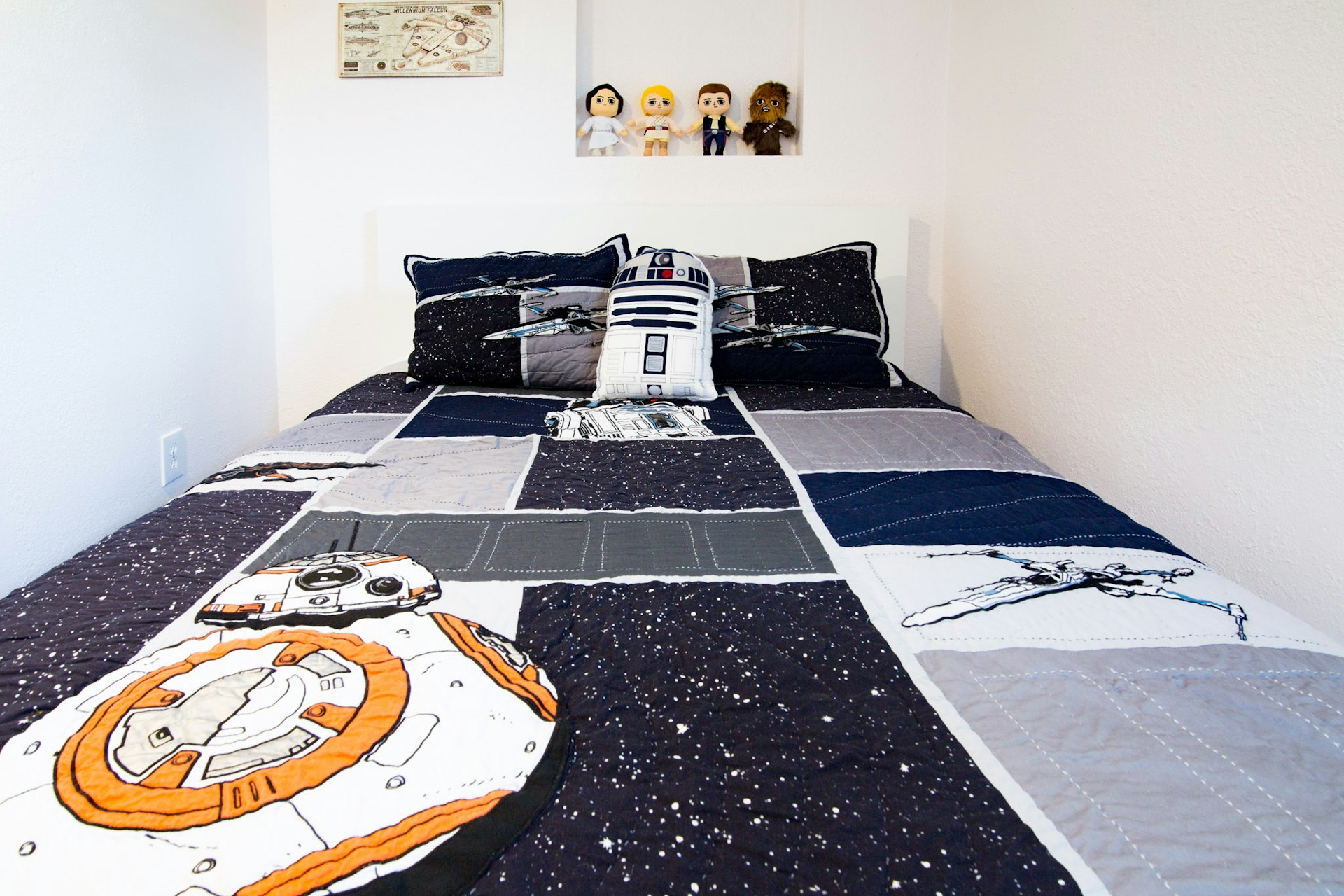 A picture of one bedroom in the Denver house featuring R2D2 plushies and decorations
