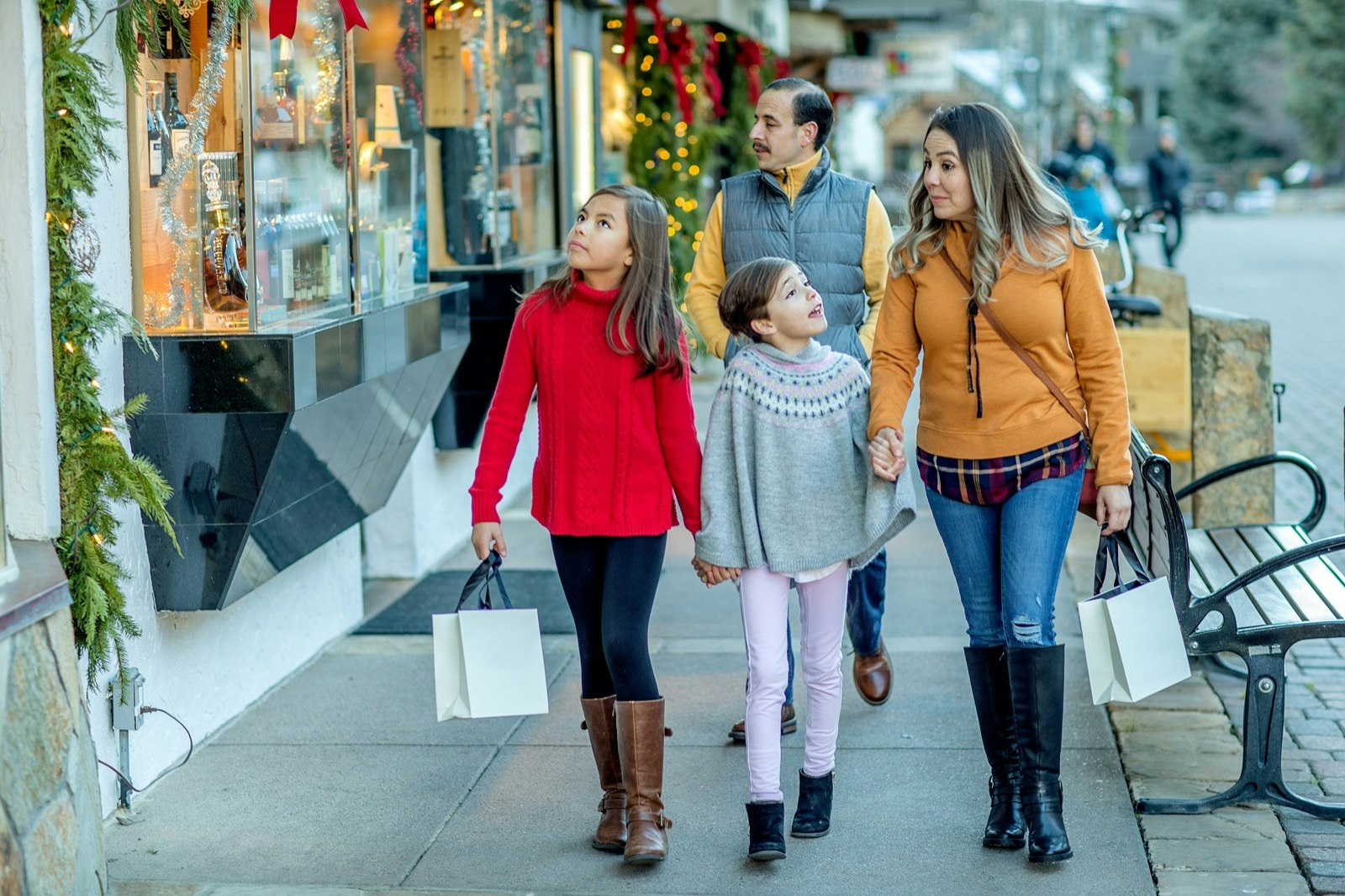 Family walks together down the street shopping in Vail Village