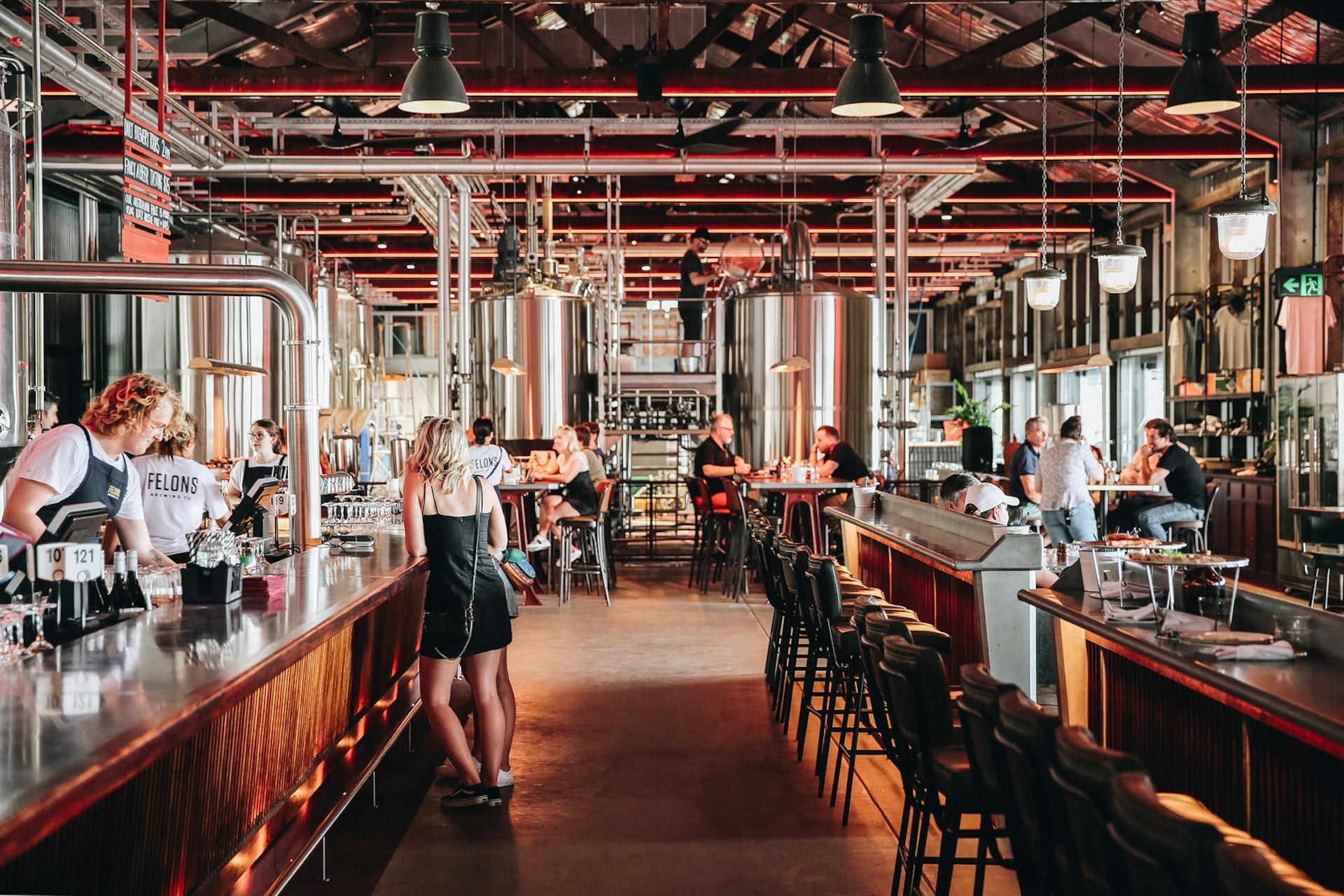 Bars run down both sides of this long, narrow brewery. Brass and stainless steel abound in this incredibly contemporary interior; people stand at the bars, others sit over tables.