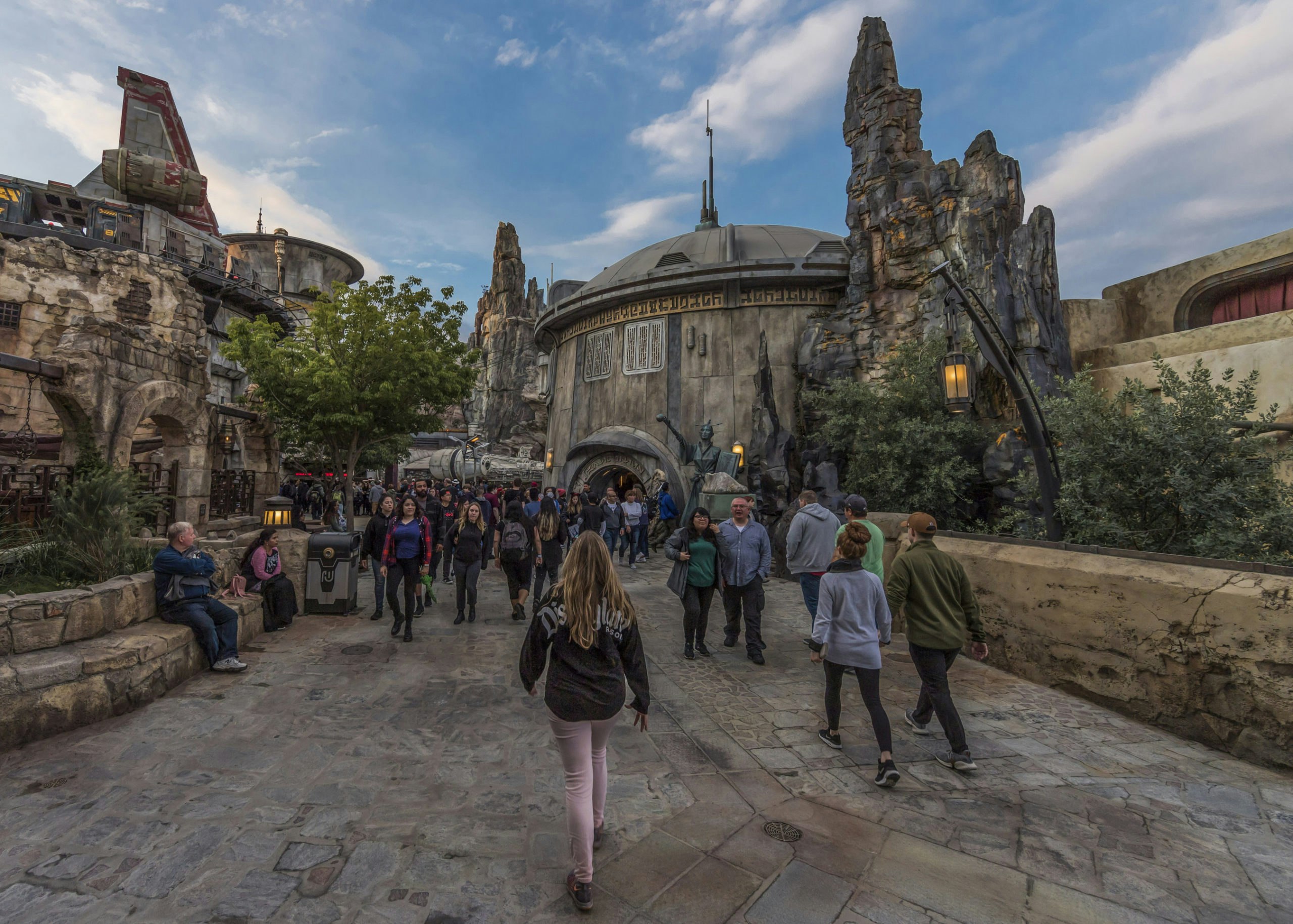 Guests wander through a replica of Black Spire Outpost, a village on the planet of Batuu, at Disneyland