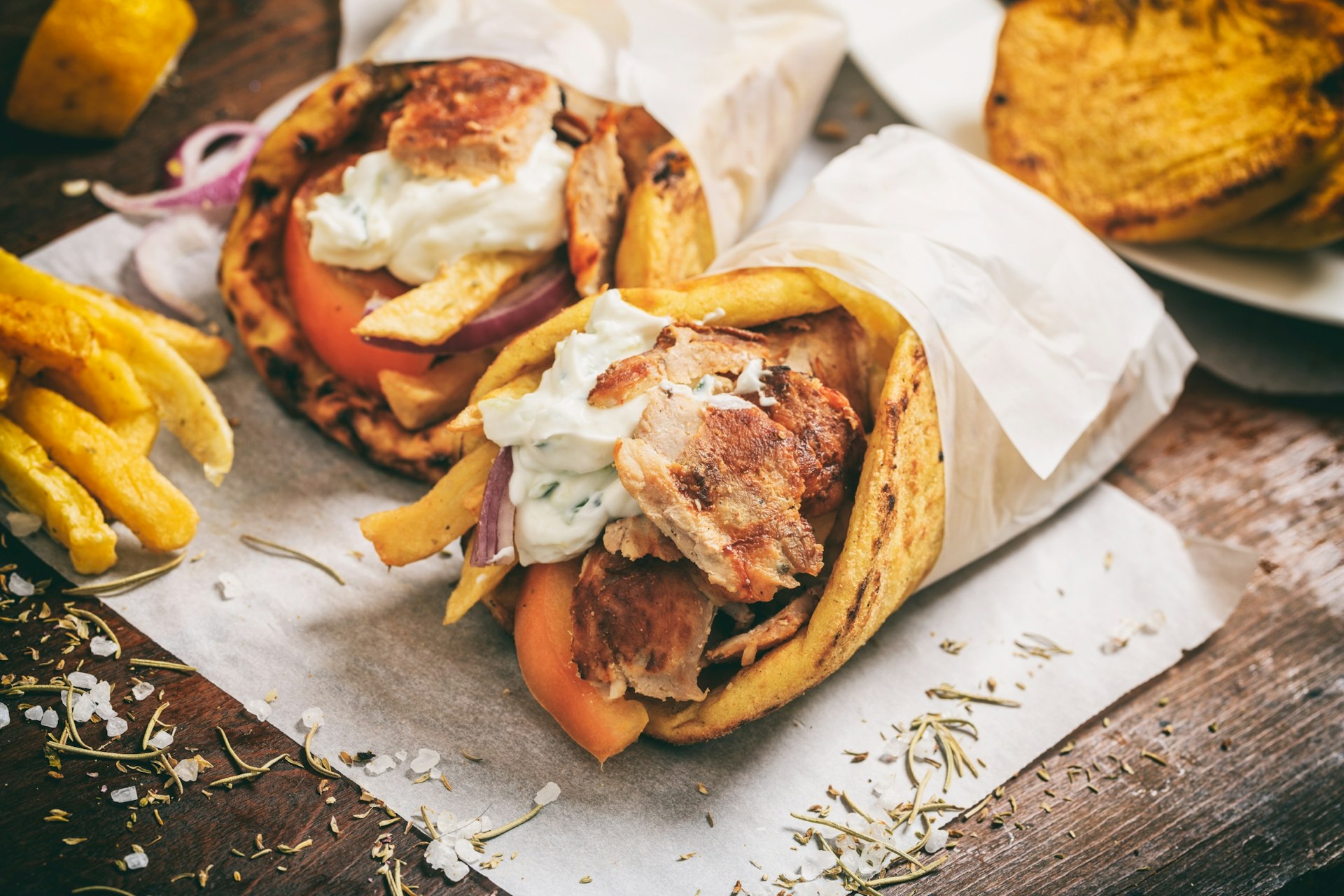 Gyros souvlaki wrapped in a pita bread on a wooden board