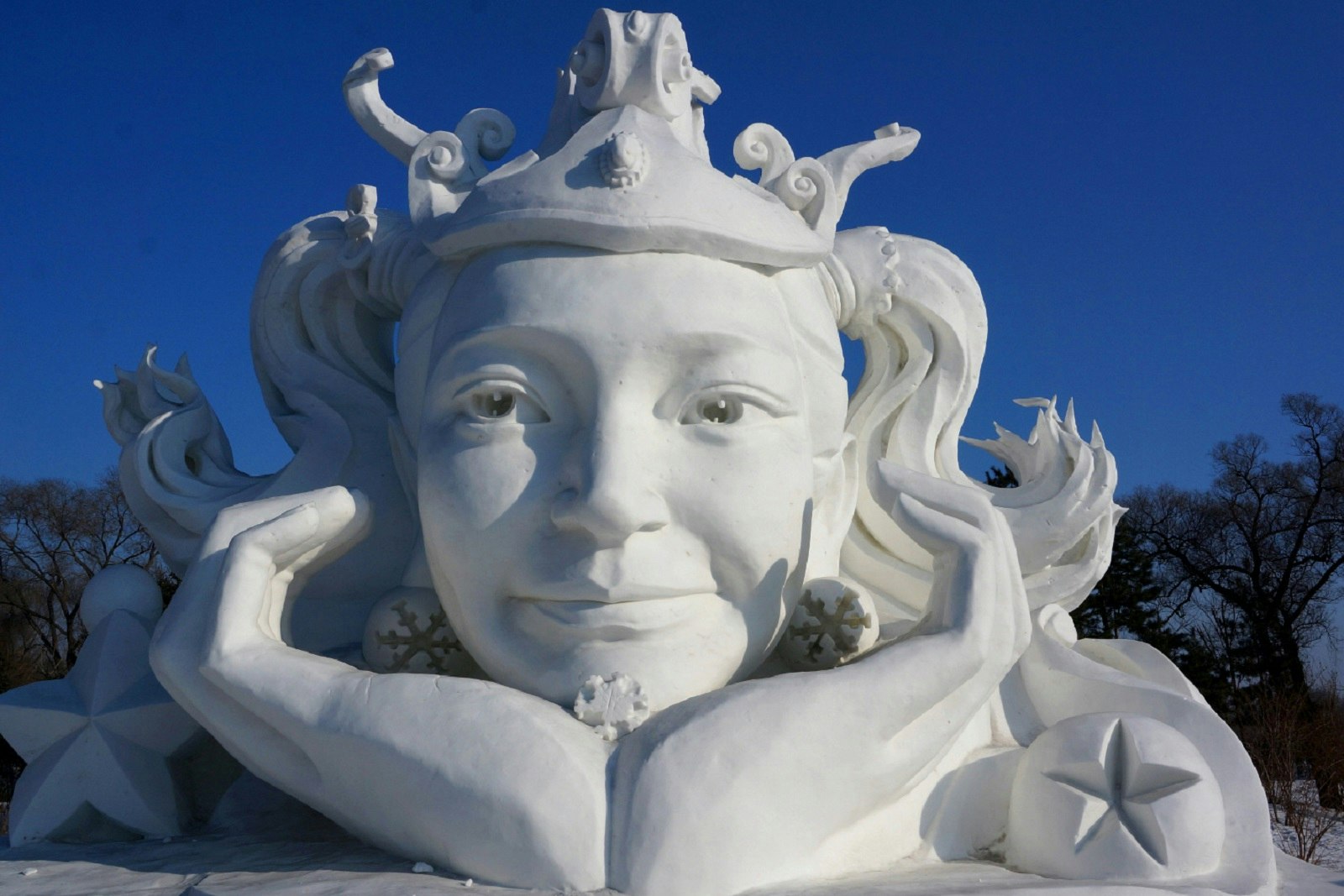 A snow sculpture, titled 'Pigtails', depicting a dreaming young woman's head. Towering nearly 20 feet tall, this sculpture was an entrant in Harbin's Snow Sculpture competition on Sun Island.