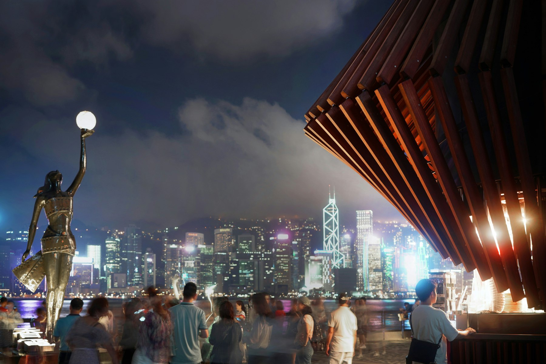 A shot of the Kiosk at night with the skyline in the background