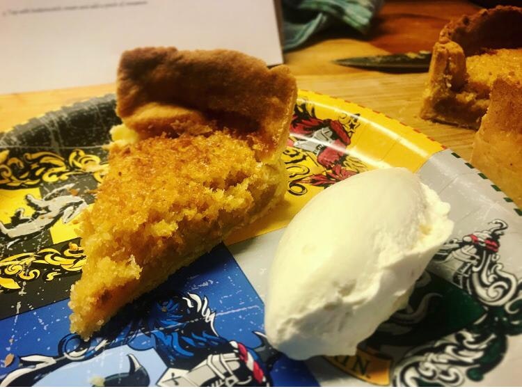 A piece of treacle tart and a scoop of ice cream on a Harry Potter themed plate