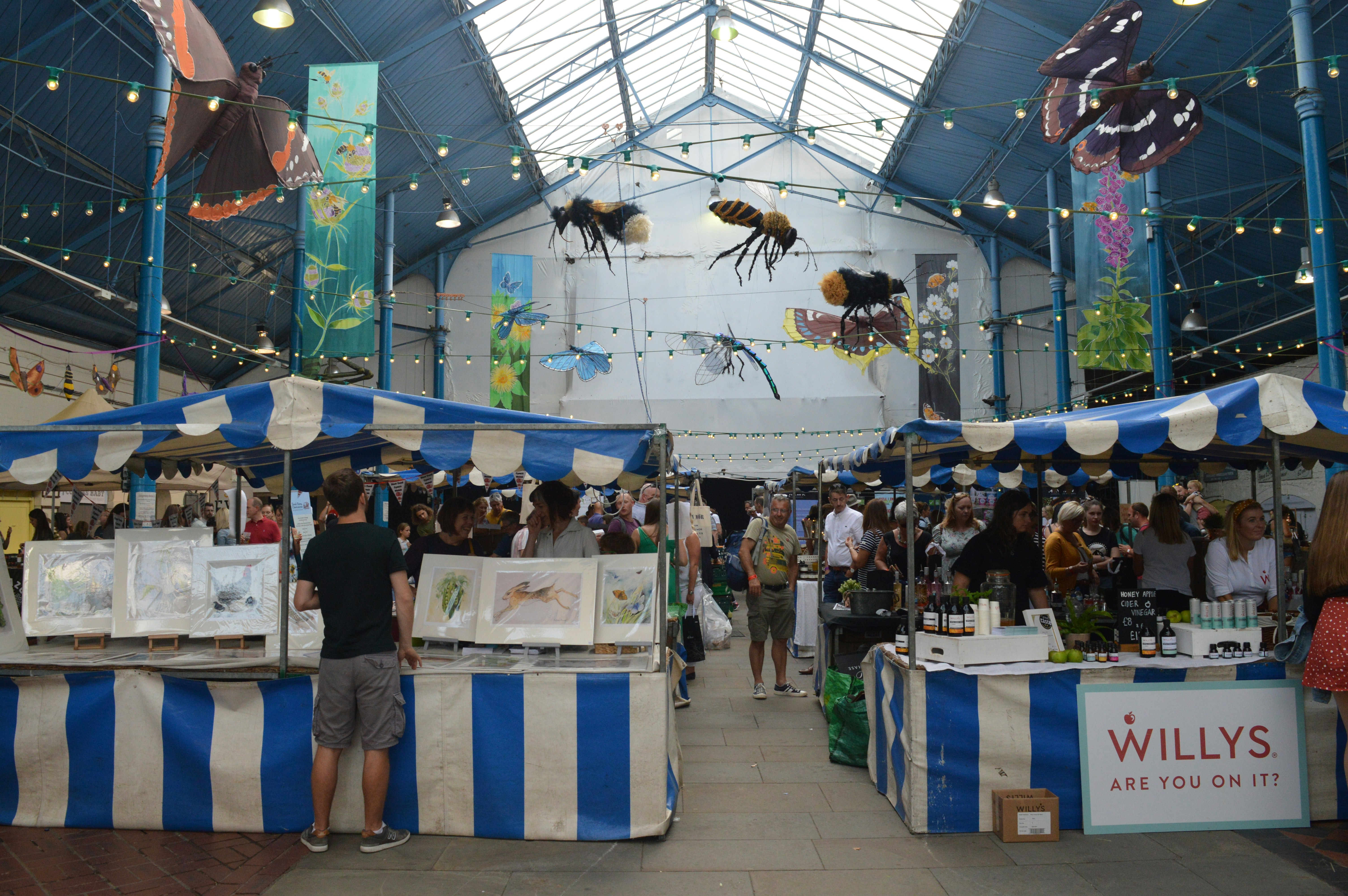The interior of the market hall in Abergavenny filled with food stalls