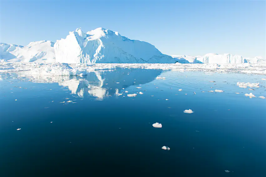 Icebergs Disko Bay in Greenland Several giant white icebergs floating through still seawater