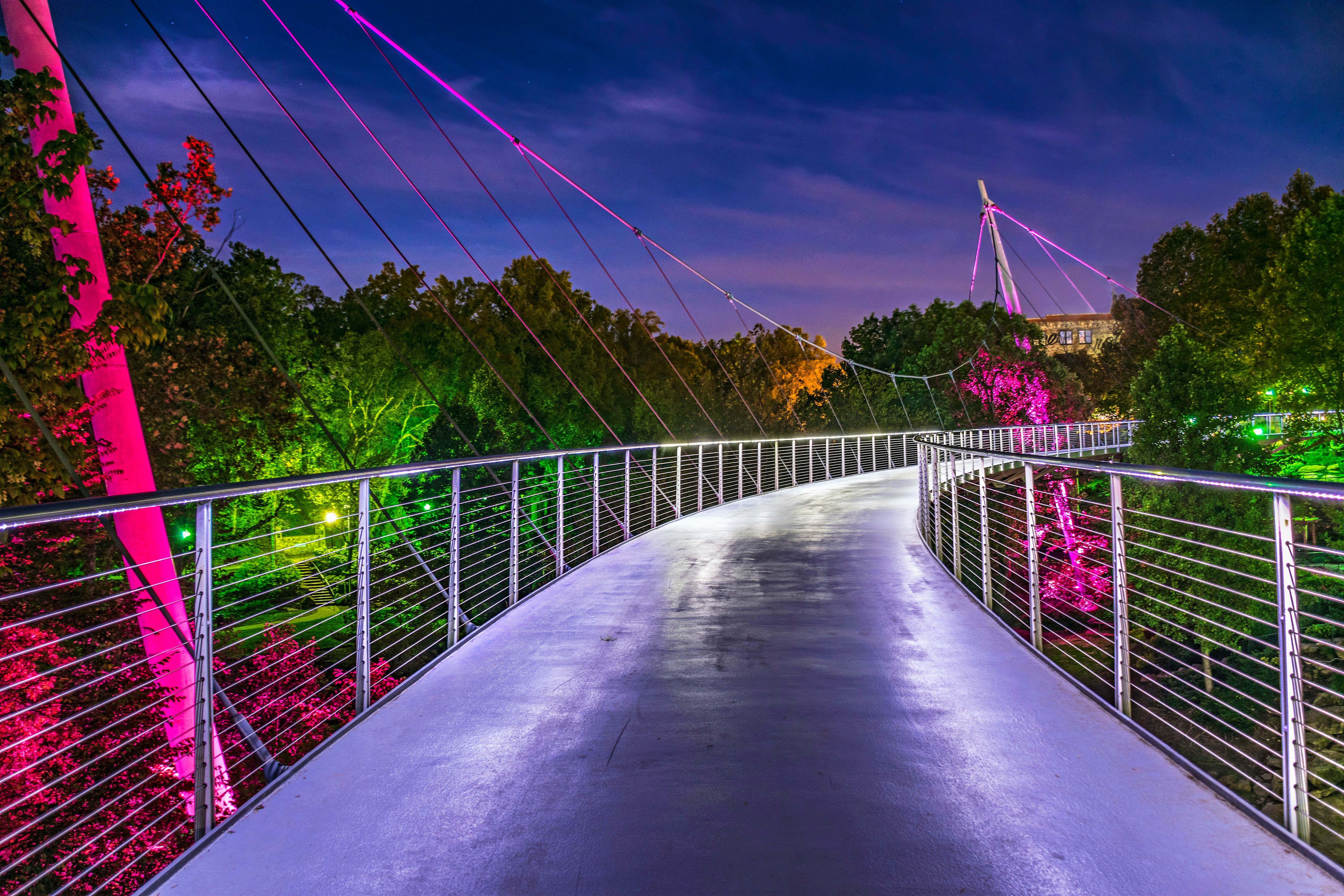 An illuminated footbridge at night