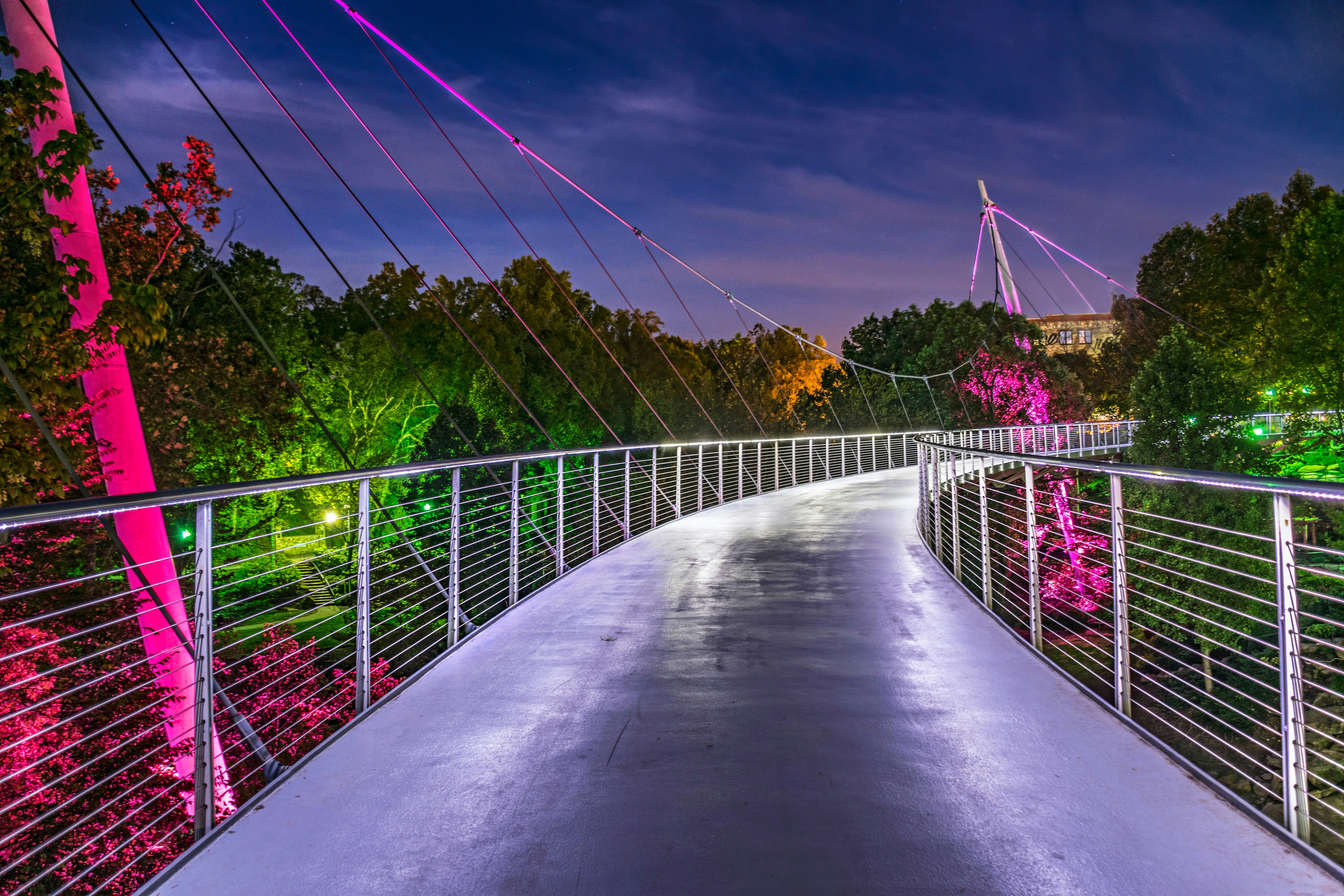 An illuminated footbridge at night