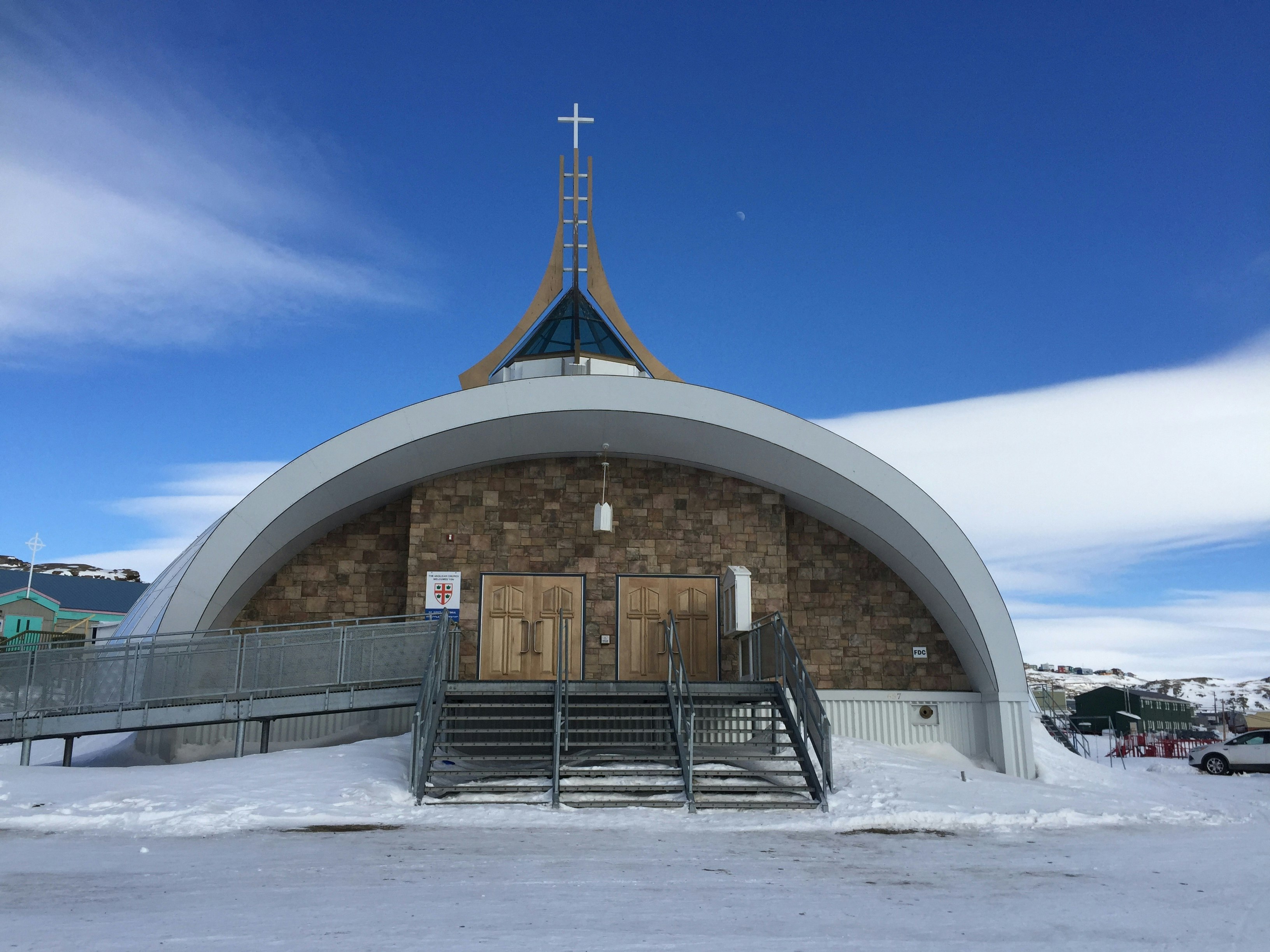 St Jude's Igloo Cathedral in Iqaluit; the structure is roughly dome-shaped to resemble an igloo, and is topped with a spire.
