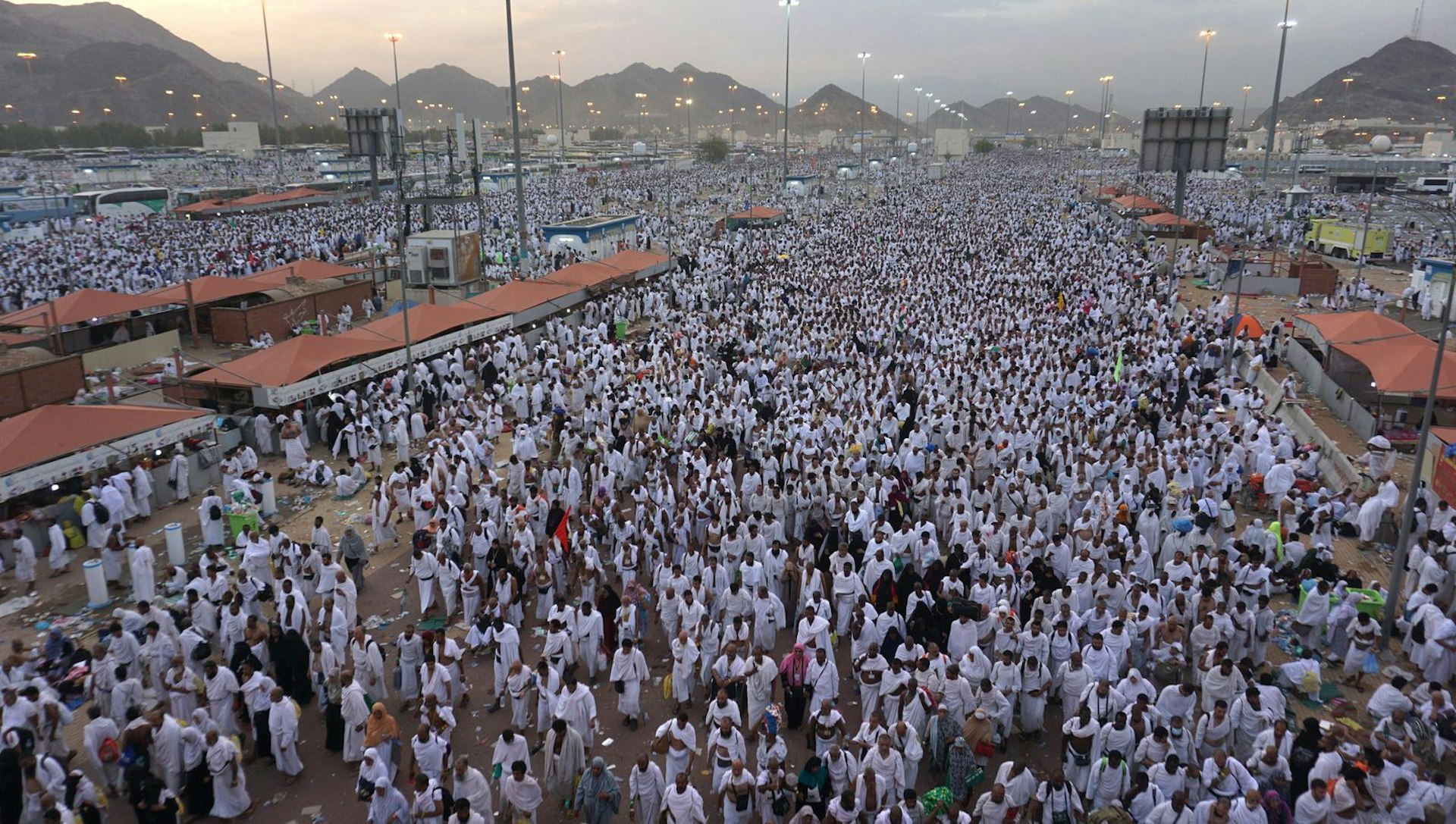 A sea of white-robed Muslim pilgrims stretches off into the distance.
