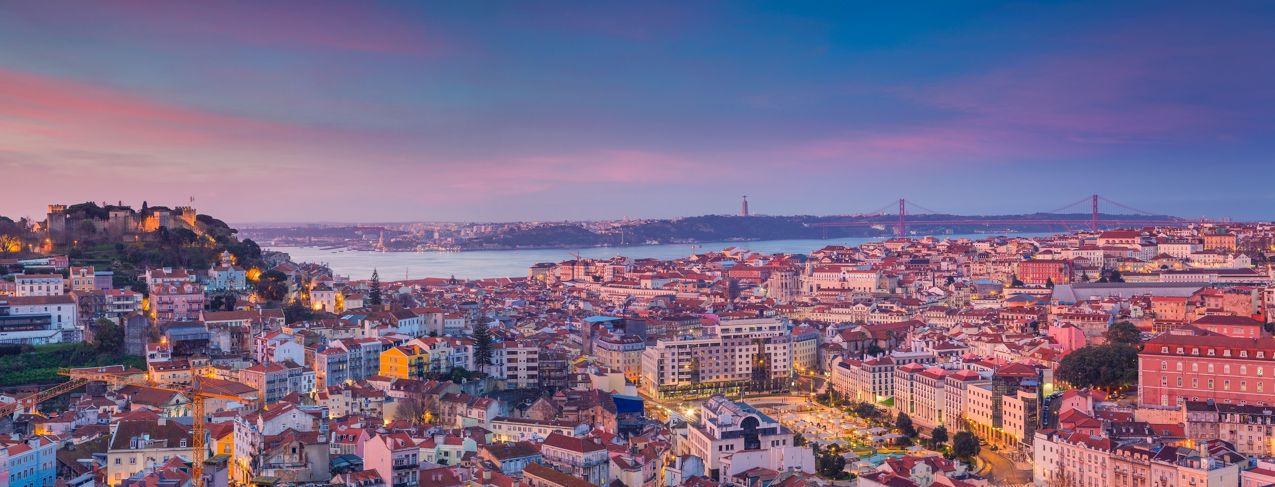 A spectacular view over the terracotta roofs of Lisbon sprawled over several hills