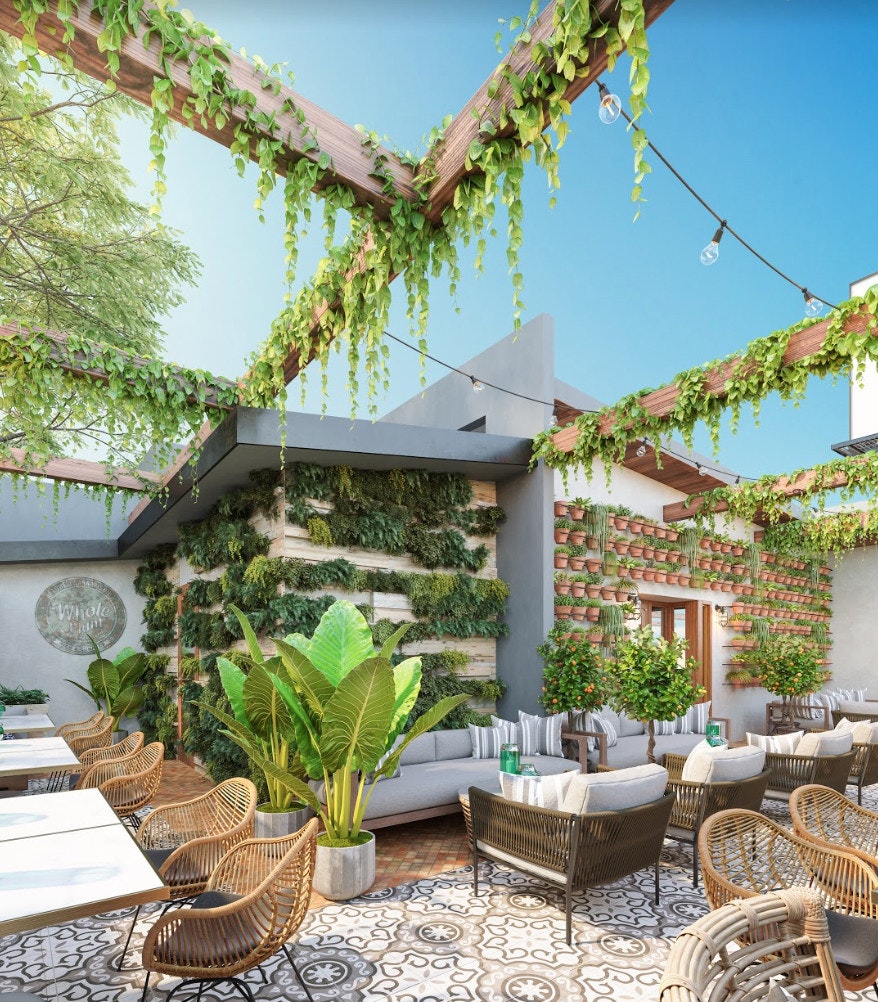 The digital rendering of the patio of Lowell Cafe, with light-coloured chairs and lots of plants decorating the space