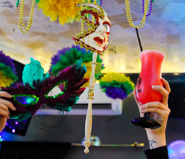 mardi gras cocktails and masks in the air.jpg