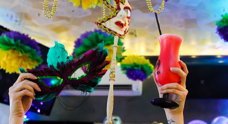 mardi gras cocktails and masks in the air.jpg