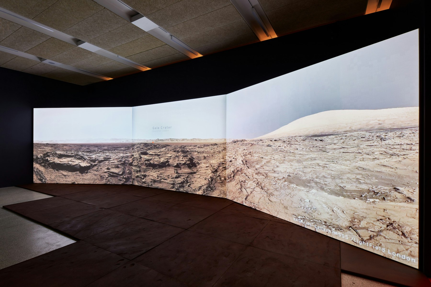 A picture of a Martian landscape on huge screens within the exhibition