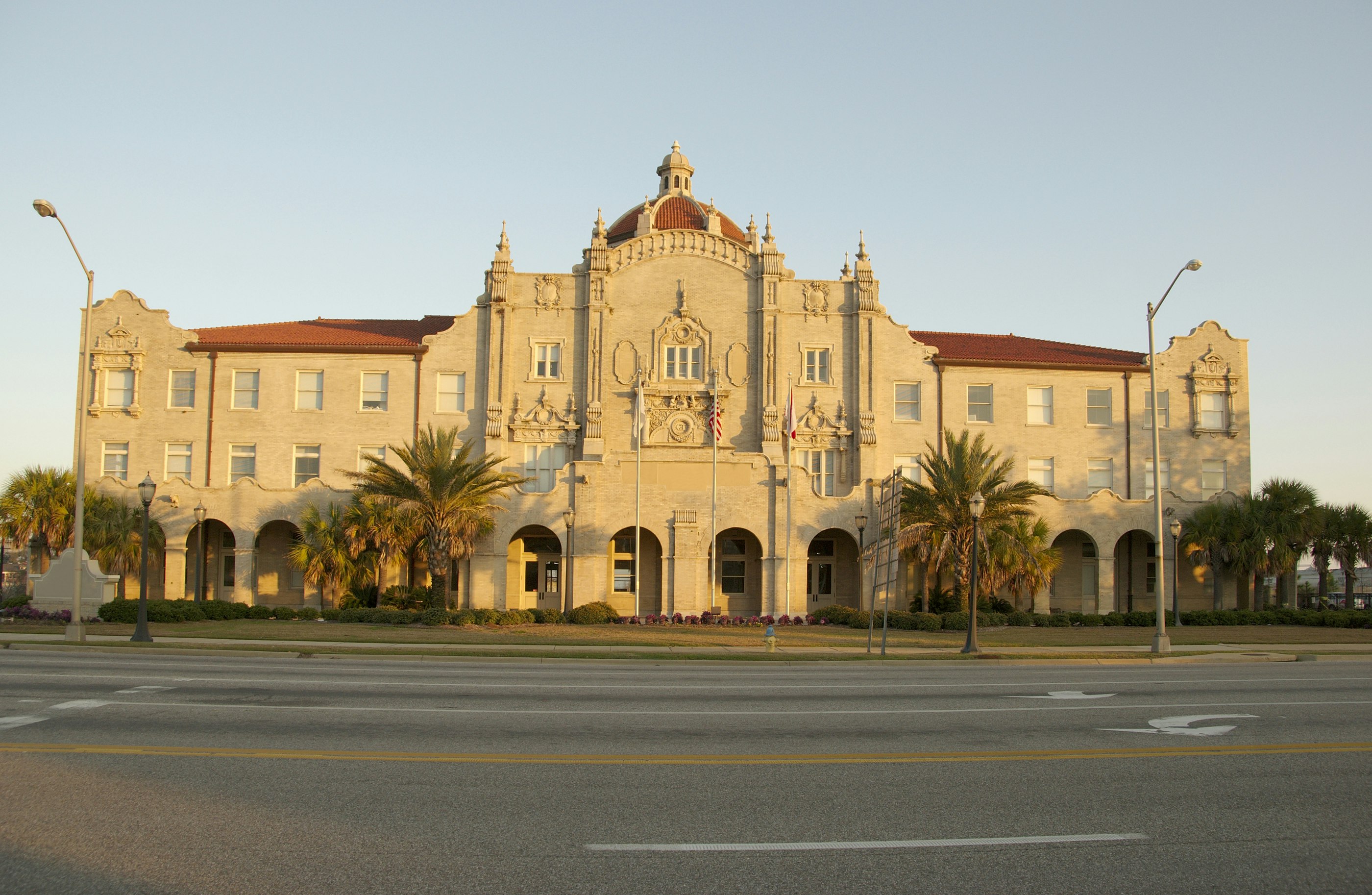 The exterior of the Gulf, Mobile, and Ohio Passenger Terminal, a historic station built in 1907 in a Mission Revival Style with a red roof and an ornate yellow-cream exterior
