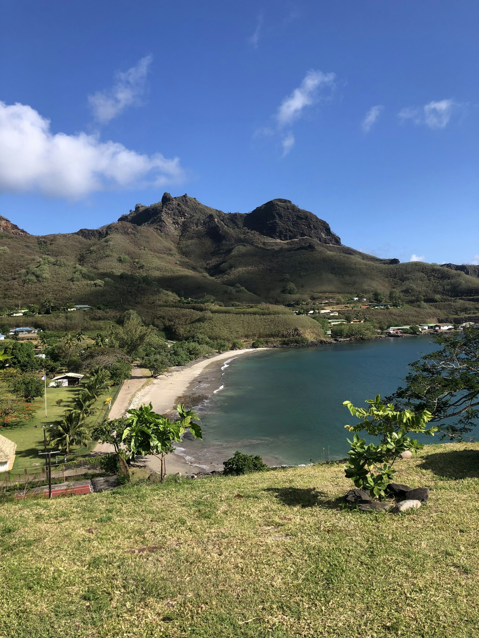 A beach in Nuku Hivu with a few buildings nearby