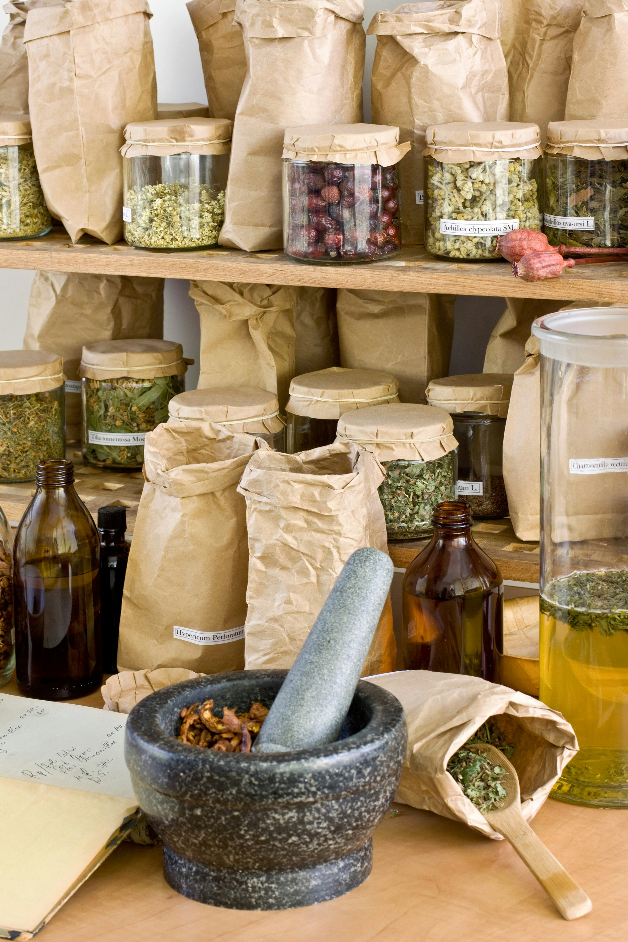 Notepad, stone mortar, pestle, bags and glass jars with assorted dried herbs..jpg