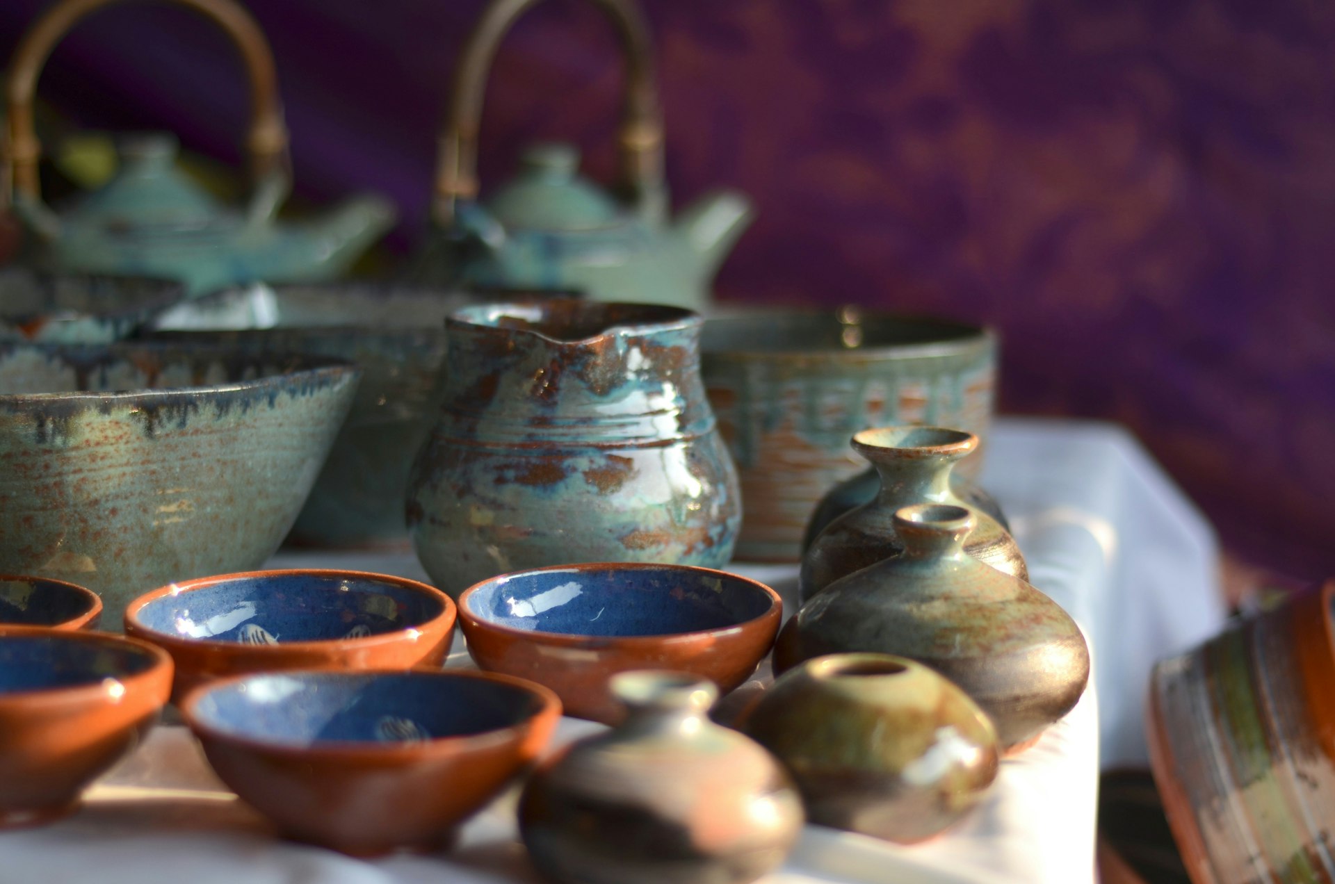 Andretta pottery on sale at a stall in Delhi. The wares include a series of small bowls, jugs and ceramic pots.