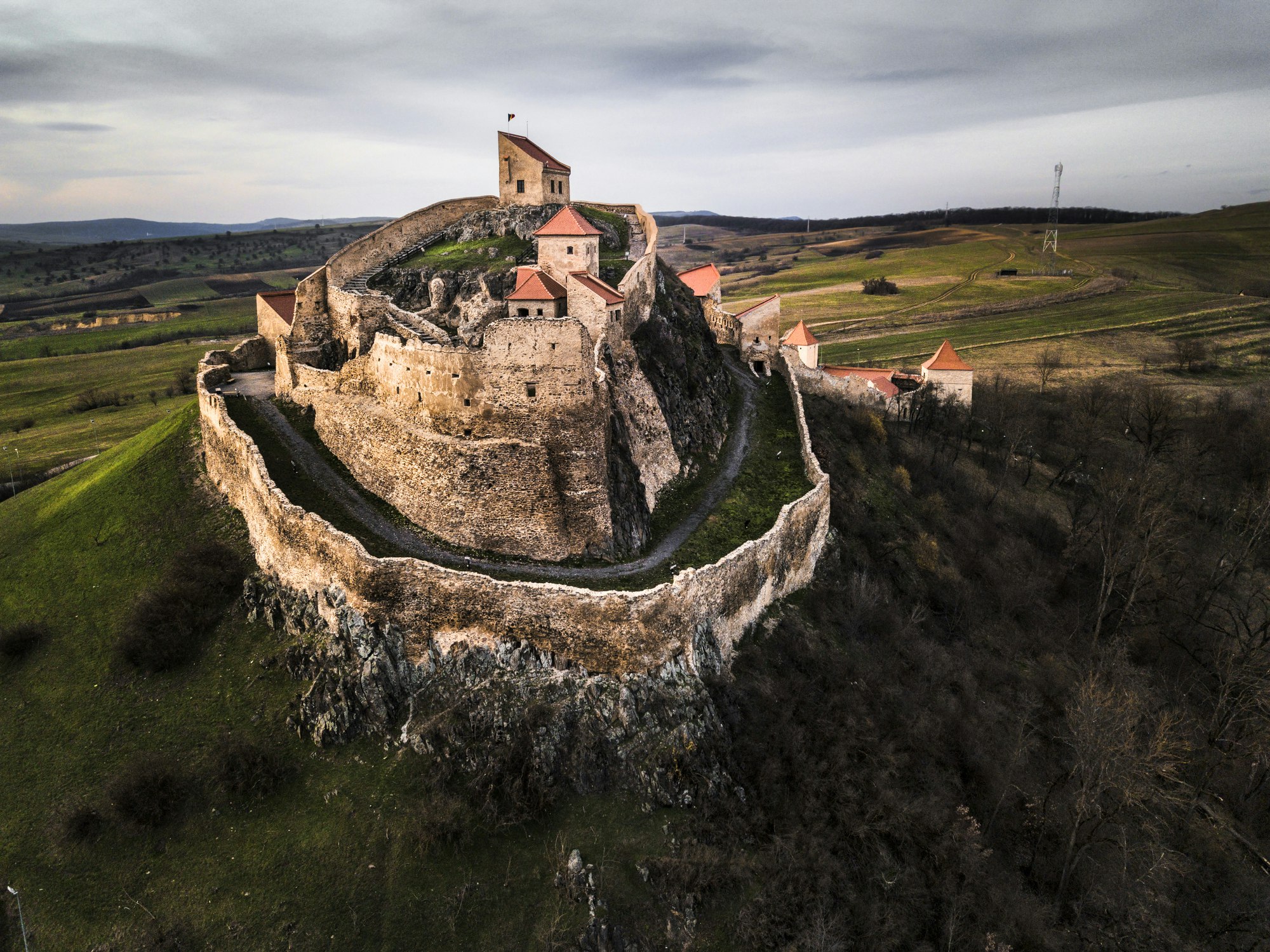 A castle on top of a hill in Romania. 