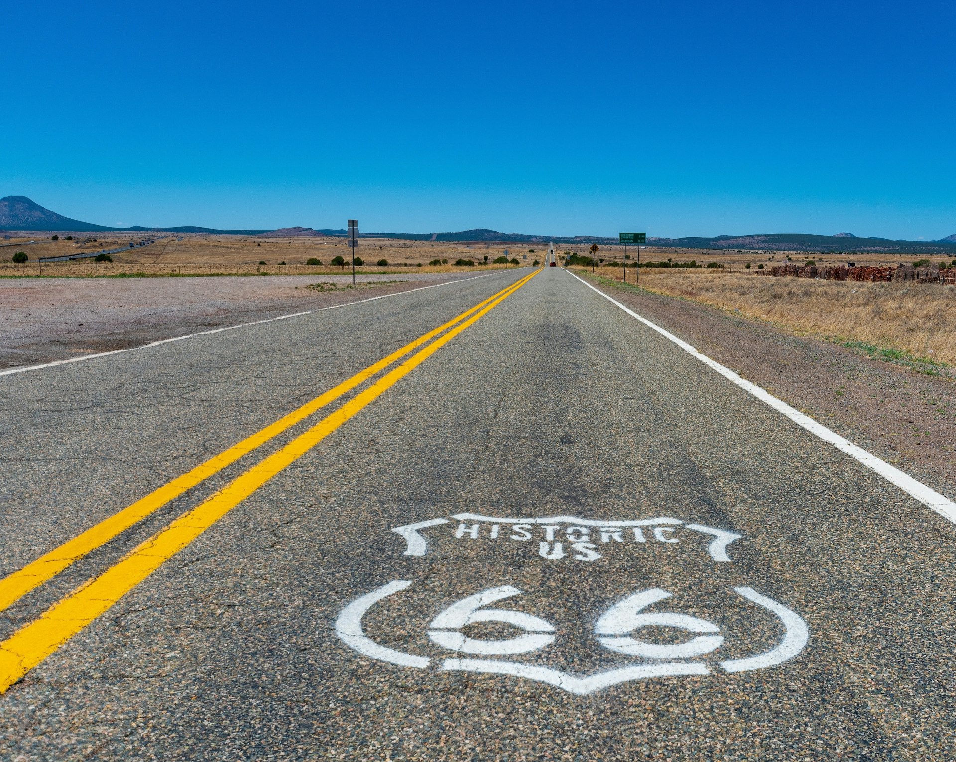 The logo of route 66 painted on a black road