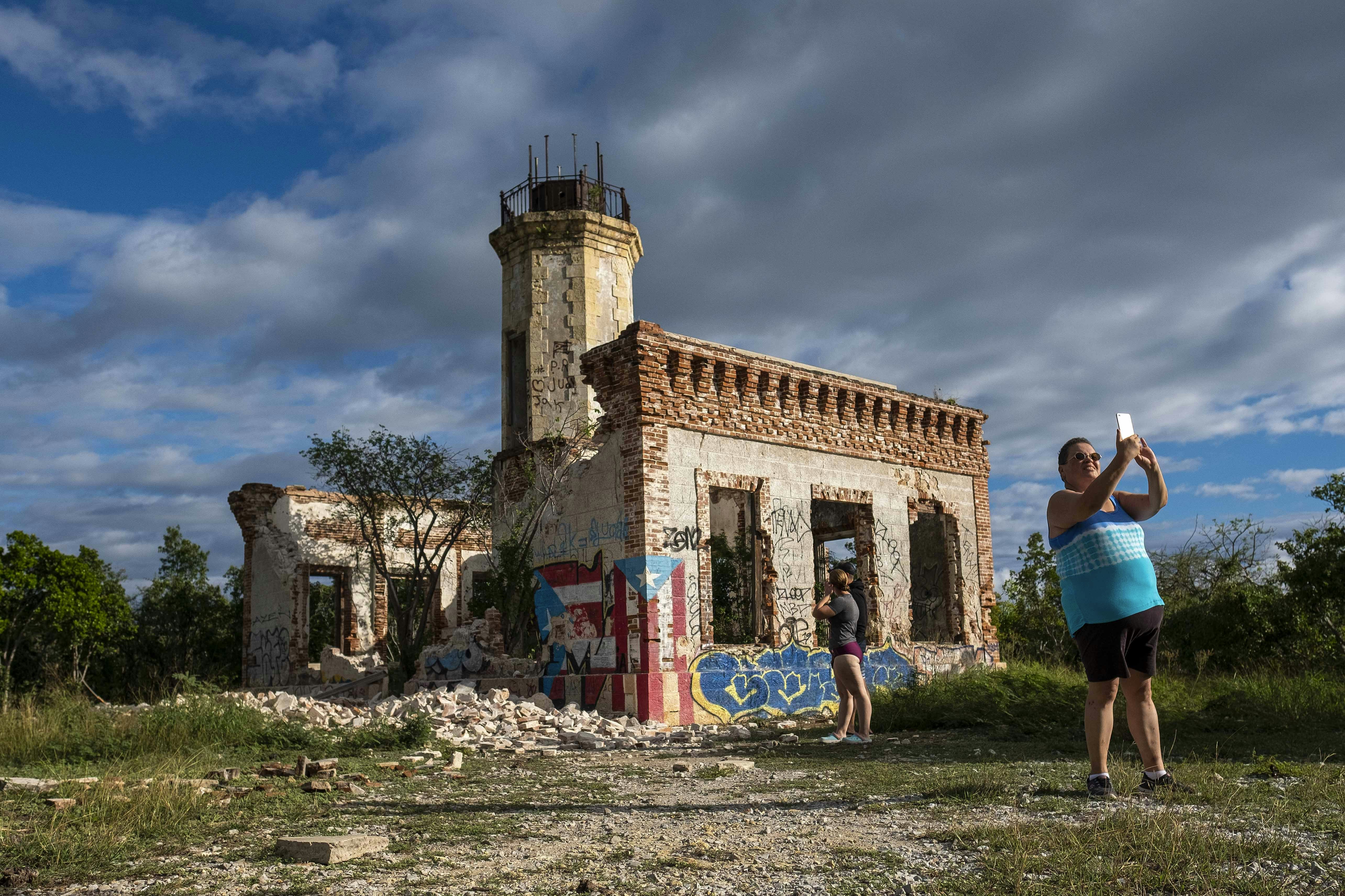 A tourist snaps a selfie at the ruins of the Guánica lighthouse, which was further damaged by the 2020 earthquakes in Puerto Rico