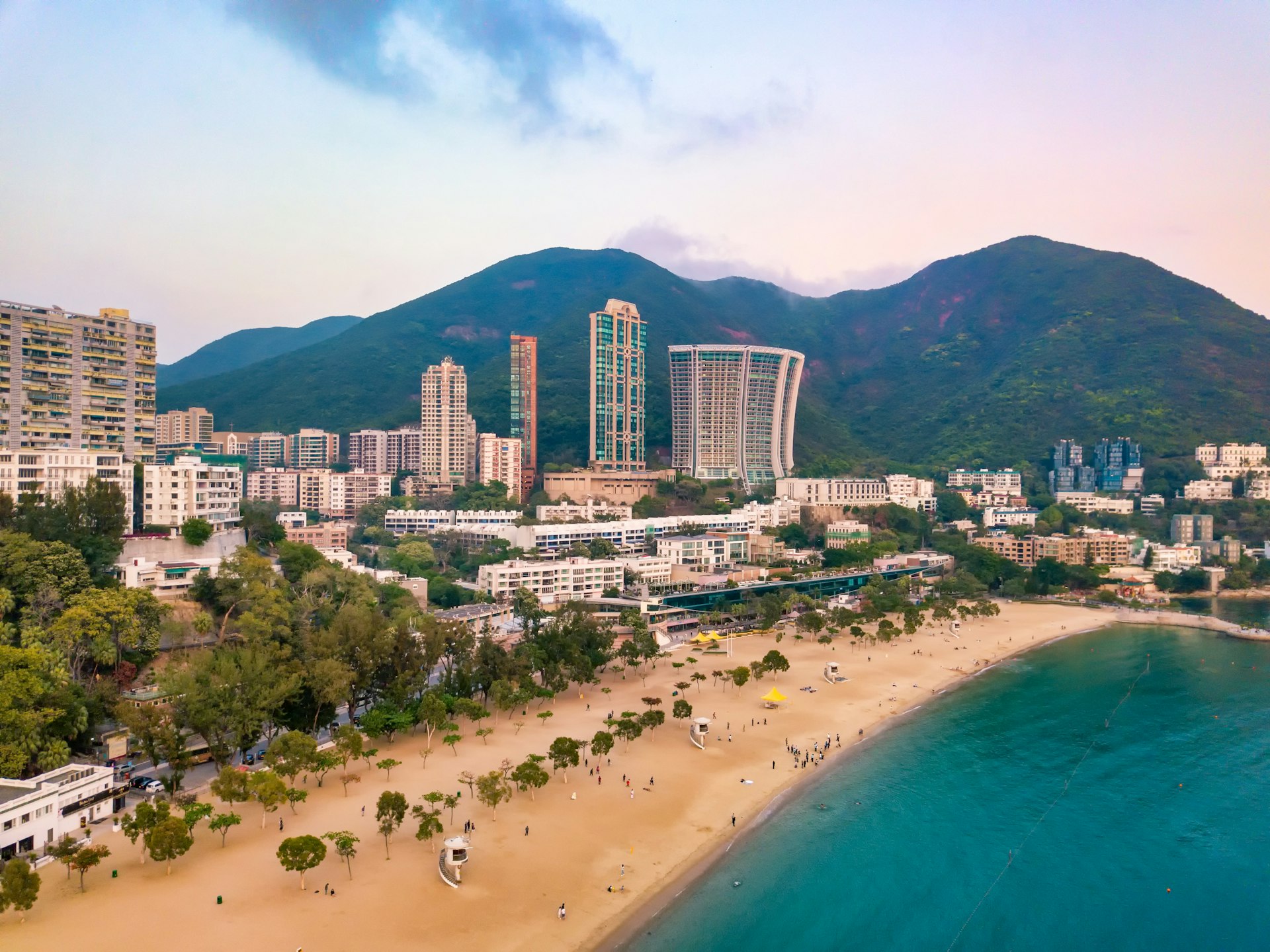 An aerial view of Repulse Bay in Hong Kong. Behind the thin strip of sand a number of the city's skyscrapers are visible.