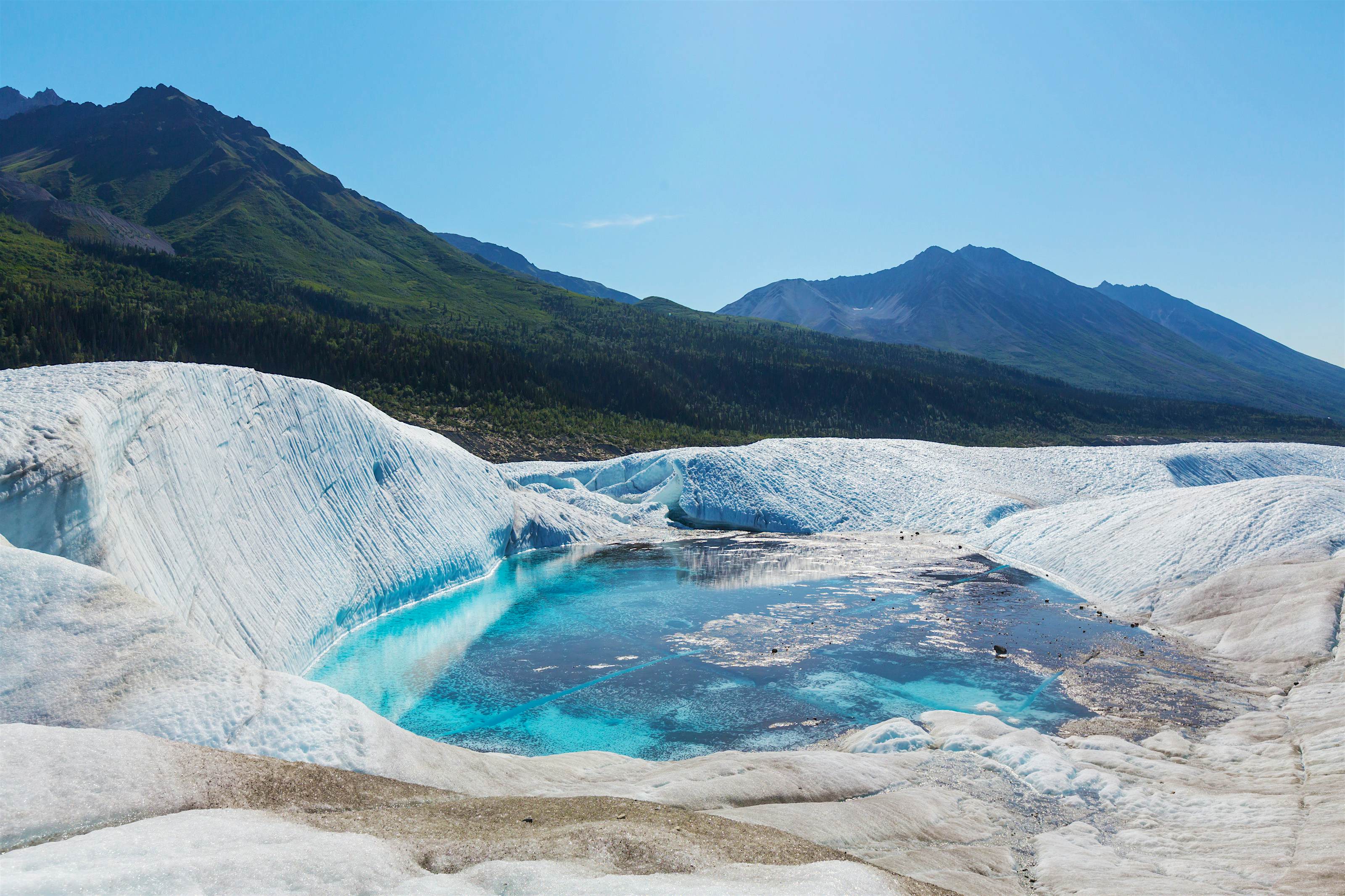 Wrangell-St. Elias National Park Vivid blue lake contrasting against the glacial ice of Alaska's Wrangell-St. Elias National Park