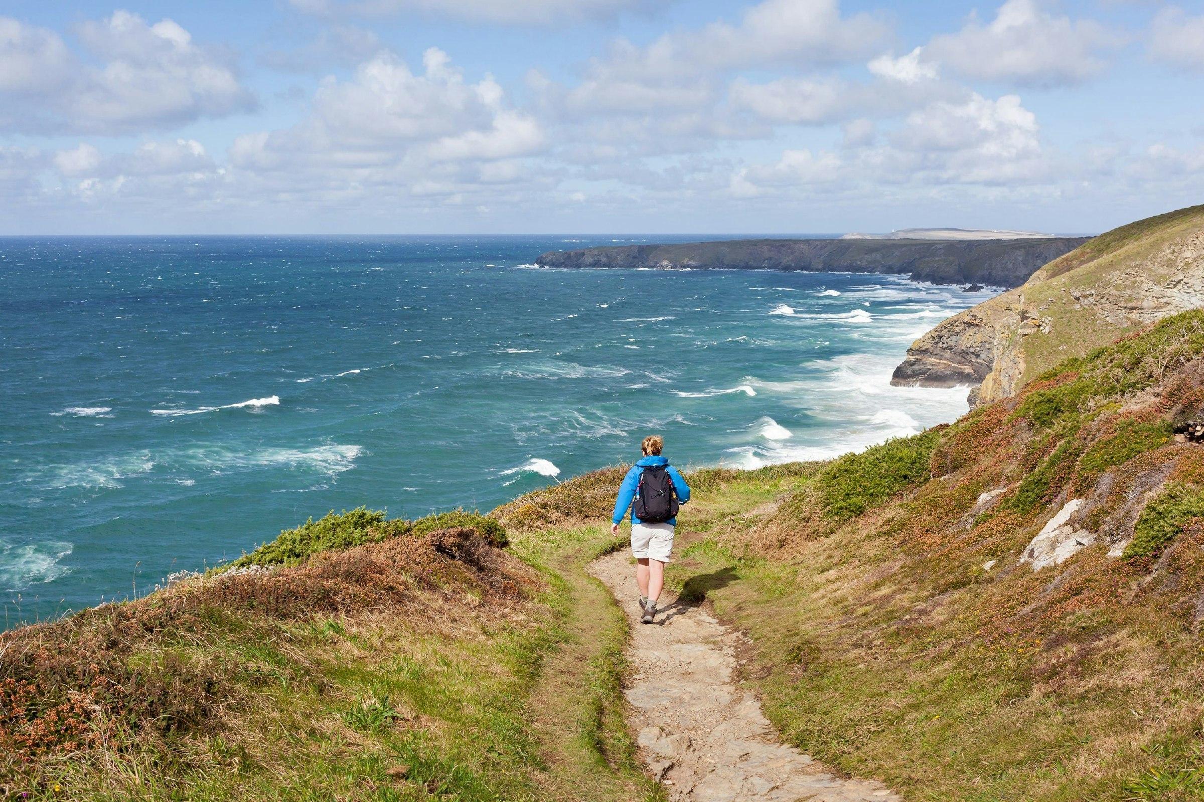 Woman walking on coastal path in Cornwall.jpg