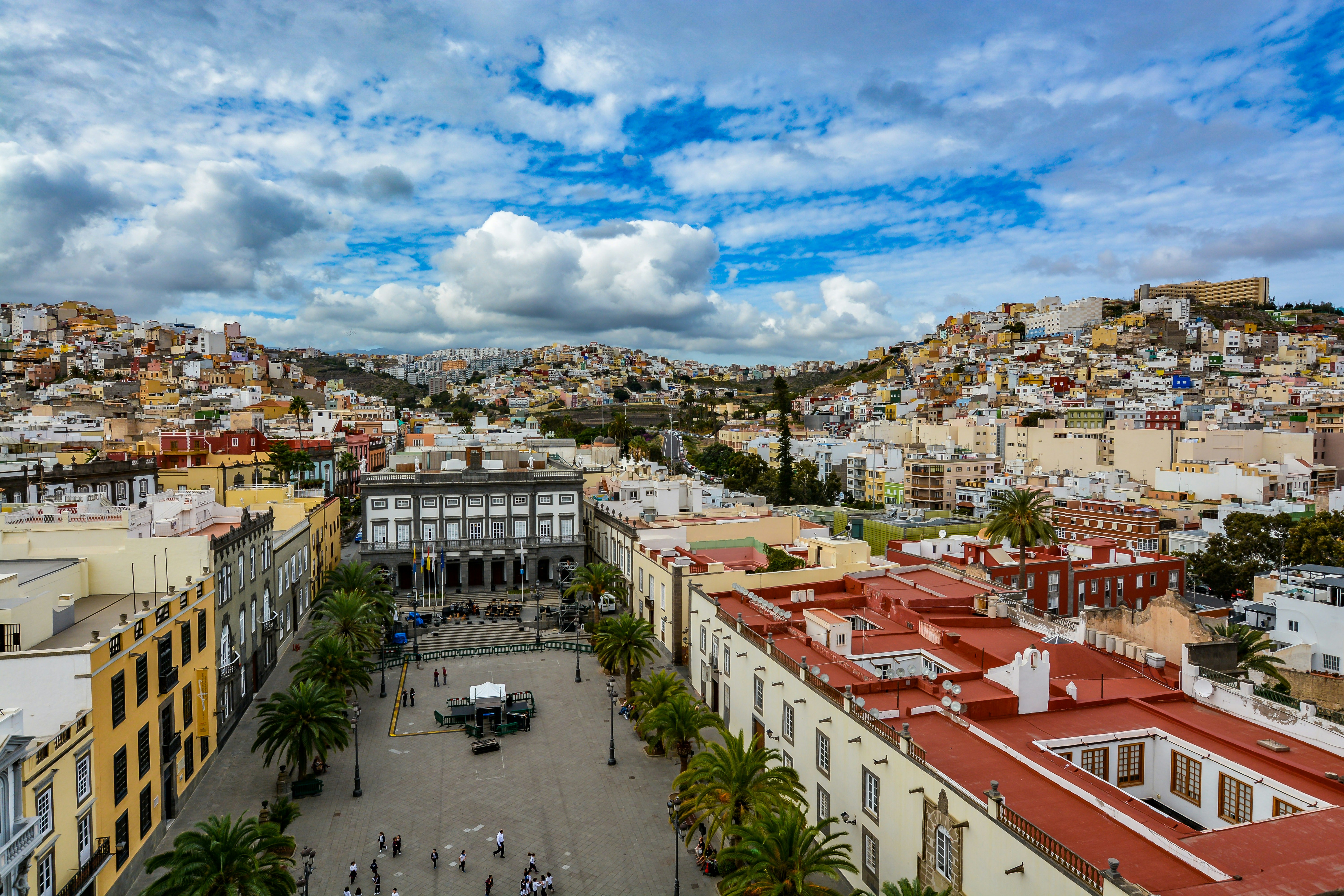 Looking over a palm-tree-lined square surrounded by colorful flat-roofed buildings in Las Palmas de Gran Canaria, Canary Islands