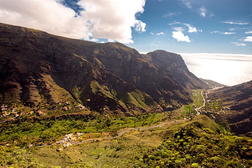 A lush green valley flanked by imposing mountains on La Gomera, Canary Islands
