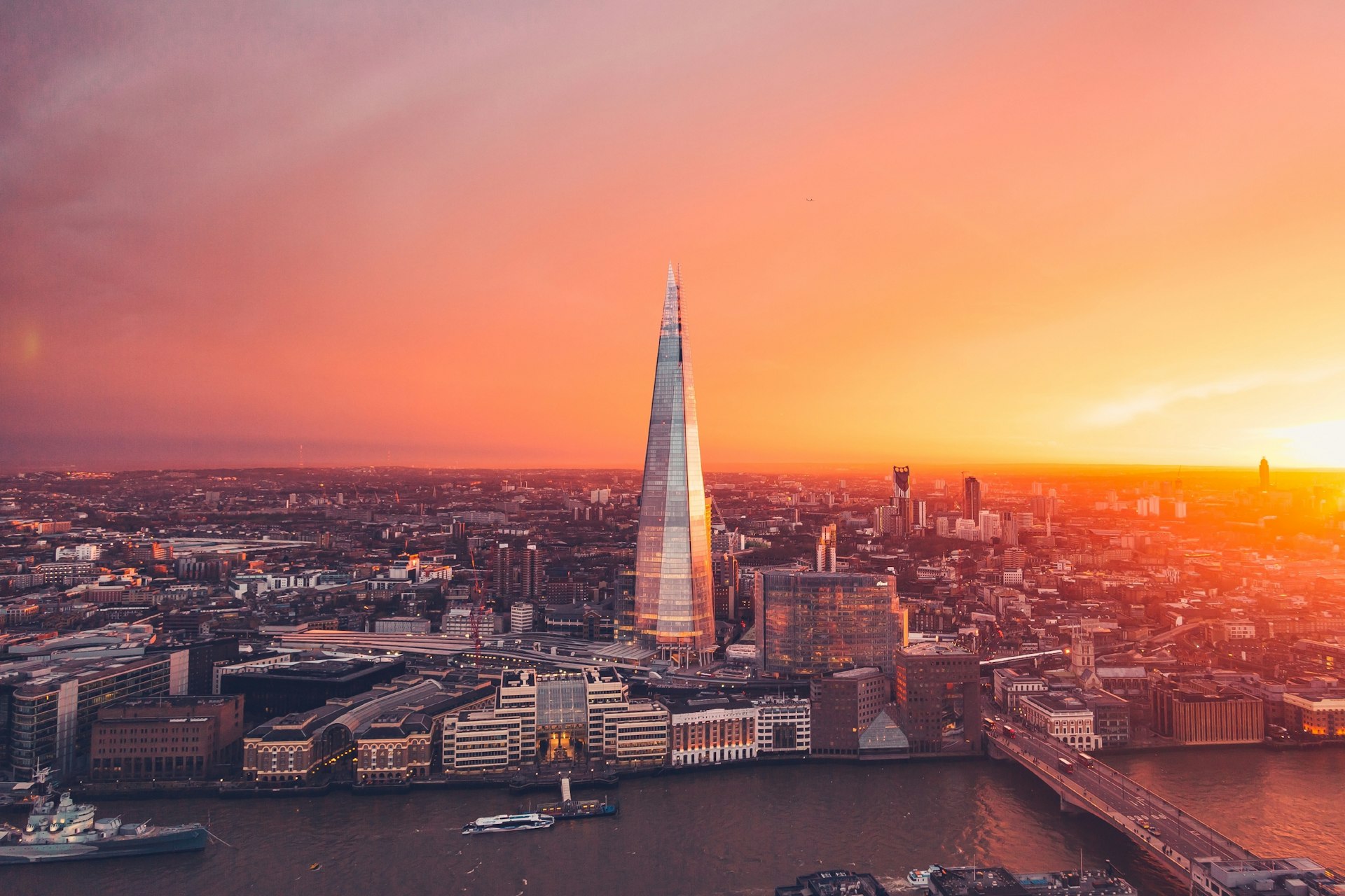 The sun sets behind the Shard in London city.