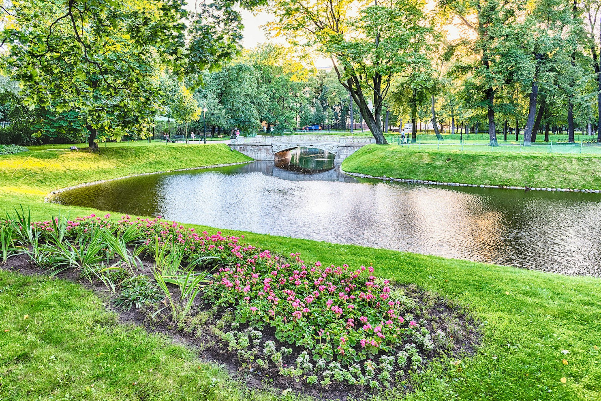 Pond and little bridge inside Mikhailovsky Garden, idillyc park in central St Petersburg, Russia