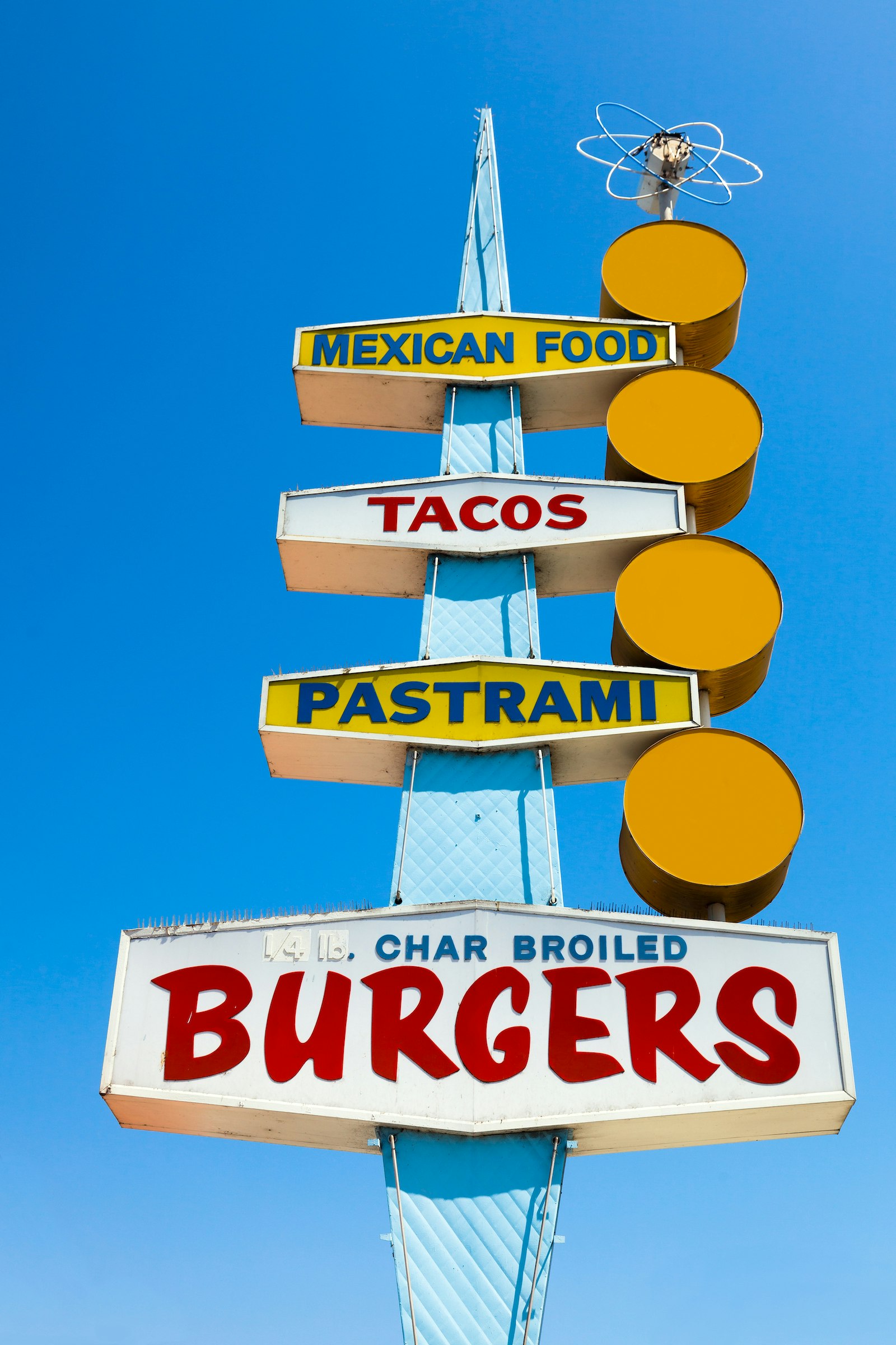 Diner sign advertising Mexican food, tacos, pastrami, and burger