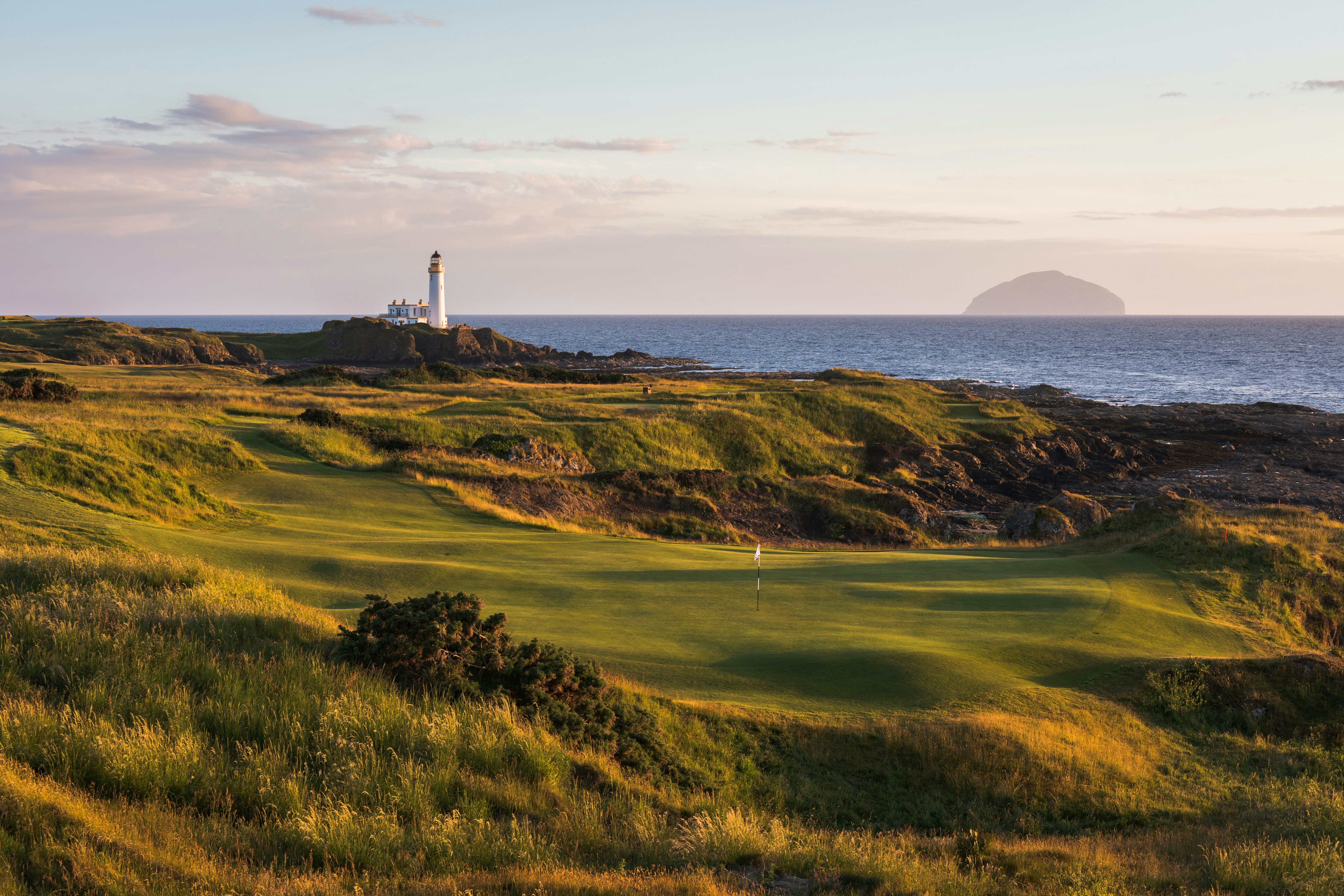 The Turnberry golf course lighthouse pictured in the distance behind rolling green hills